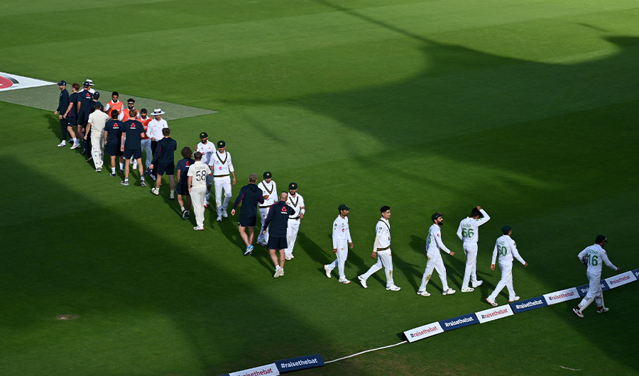 Players of both teams bump arms after agreeing to end the game as a draw on the fifth day of the second Test cricket match between England and Pakistan at the Ageas Bowl in Southampton, southwest England on August 17, 2020. (AFP)