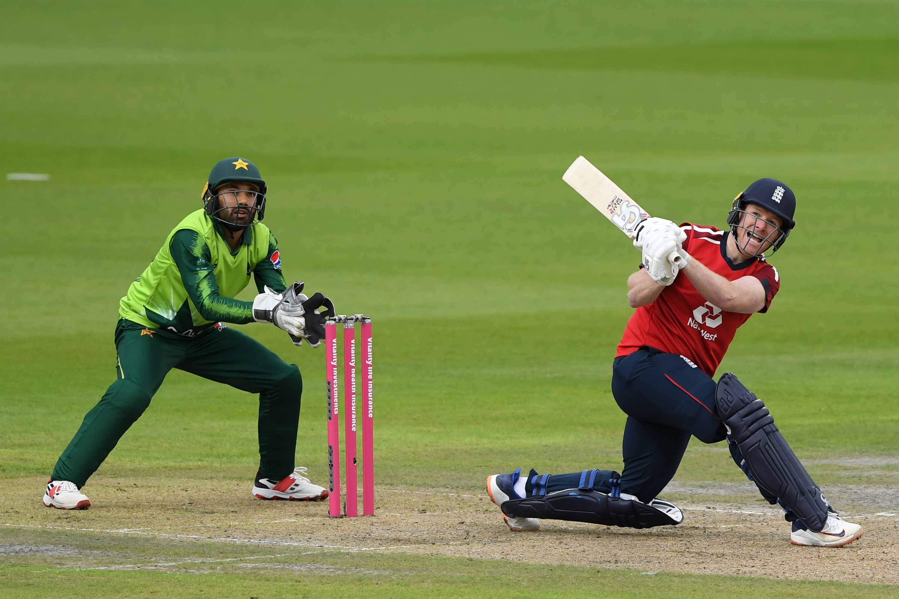 England's Eoin Morgan hits a six as Pakistan's Mohammad Rizwan keeps wicket during the international Twenty20 cricket match between England and Pakistan at Old Trafford cricket ground in Manchester, north-west England, on August 28, 2020. (AFP)