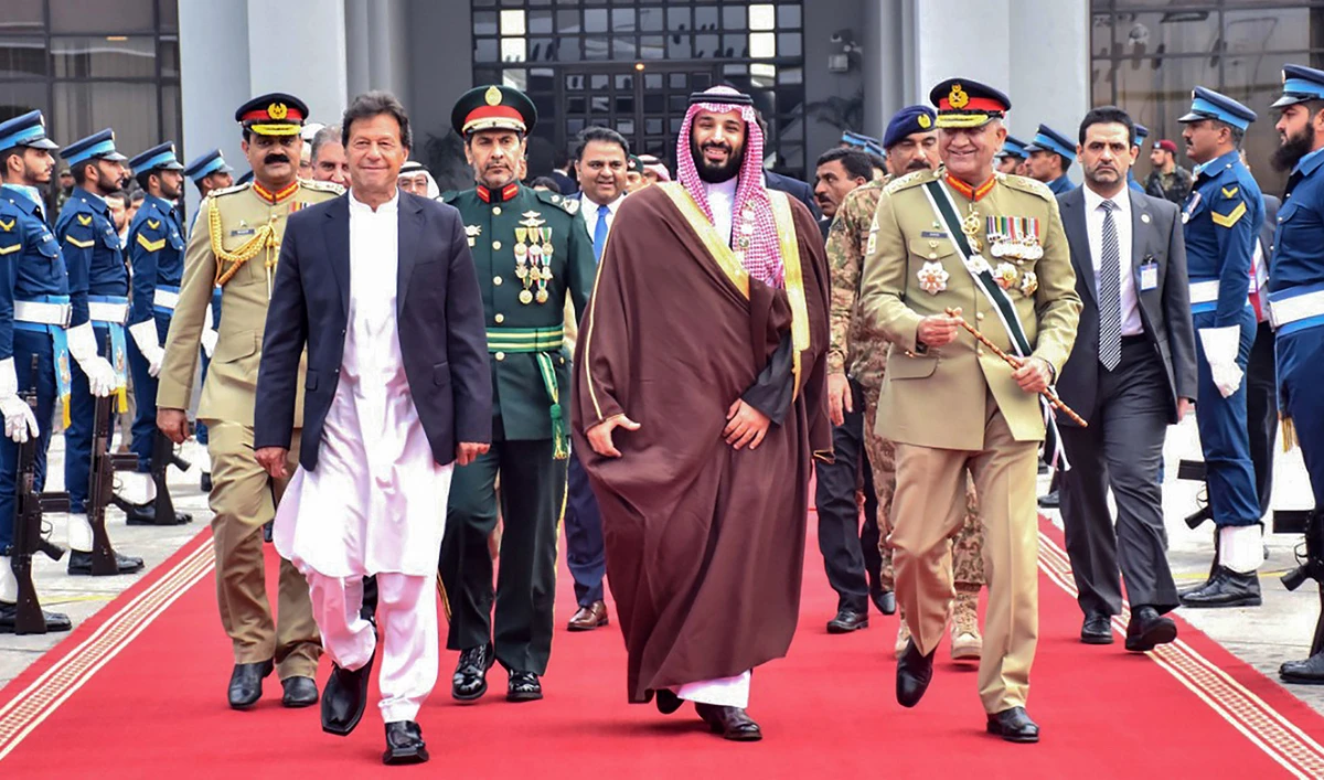 This photograph released by Pakistan's Prime Minister House (PMH) on Feb. 18, 2019 shows premier Imran Khan, second left, army chief General Qamar Javed Bajwa, right, walk along with Saudi Arabian Crown Prince Mohammed bin Salman, second right, on his departure from the Nur Khan Pakistan Air Force (PAF) base in Islamabad. (Pakistan's Prime Minister House via AFP)
