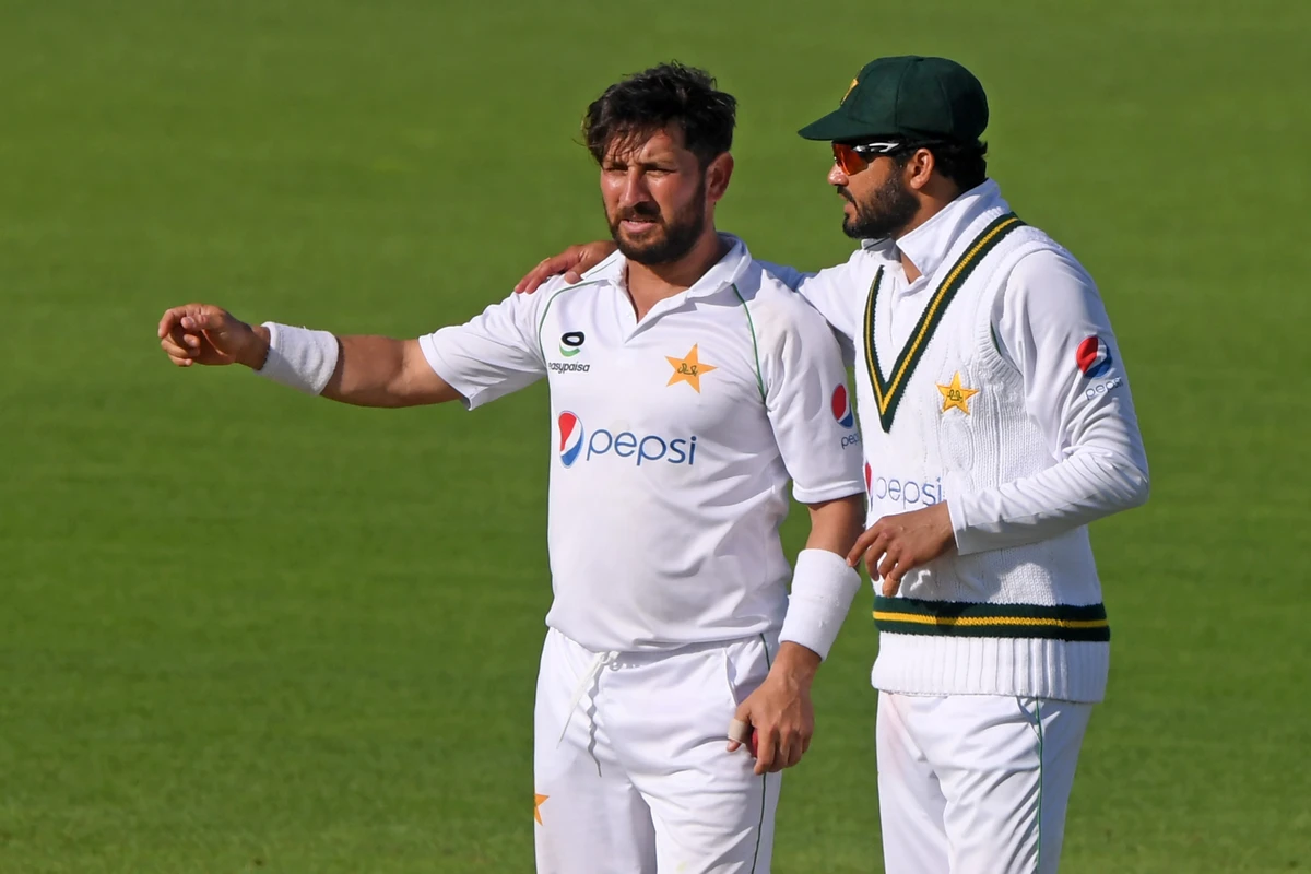 Pakistan's Azhar Ali (R) speaks with Pakistan's Yasir Shah (L) during play on the fifth day of the second Test cricket match between England and Pakistan at the Ageas Bowl in Southampton, southwest England on August 17, 2020. (AFP)