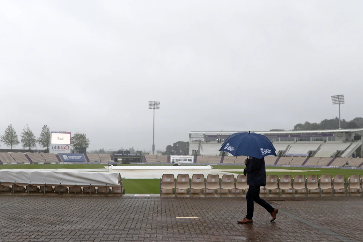 Umbrellas are the order of the day as rain prevents play starting on time on the fifth day of the third Test cricket match between England and Pakistan at the Ageas Bowl in Southampton, southern England on August 25, 2020. (AFP)