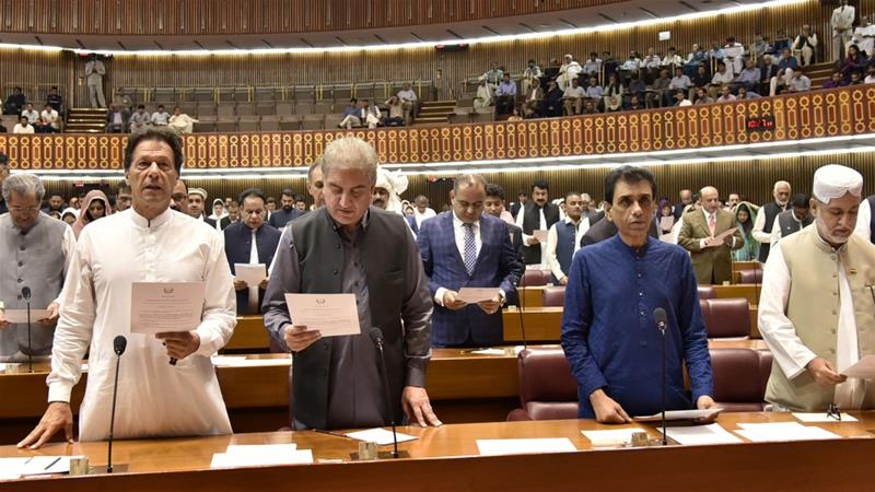 A hand out image made available by the Pakistan National Assembly on August 13, 2018, shows (from L to R) Pakistan's cricketer-turned politician and head of the Pakistan Tehreek-e-Insaf (Movement for Justice) party Imran Khan, Shah Mahmood Qureshi, Khalid Maqbool , Sardar Akhtar Mengal and others taking the oath as Members of Parliament during the first session of the Parliament in Islamabad following general election. (AFP)
