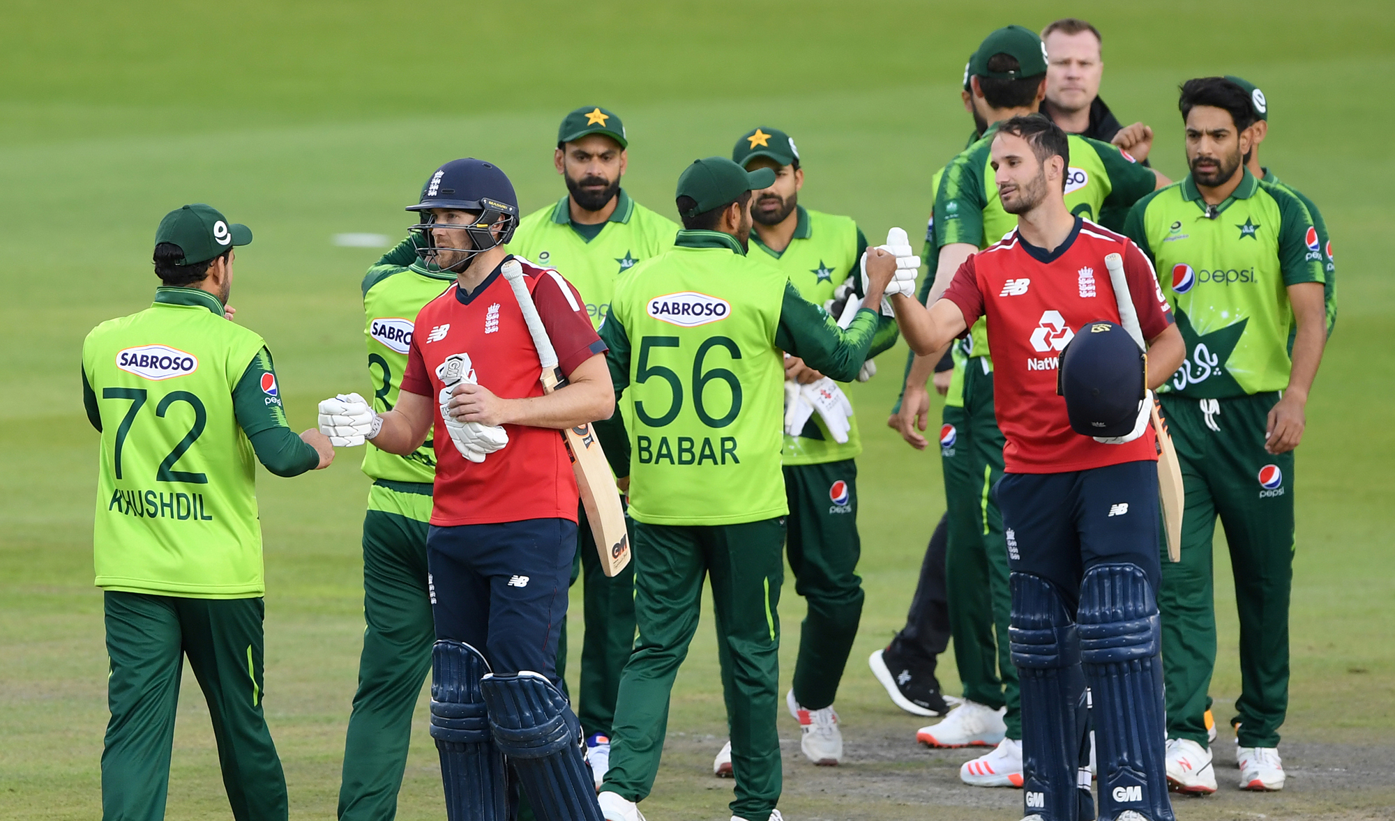 England's Dawid Malan and Lewis Gregory shake hands with Pakistan players after a T20 match between the two teams at Emirates Old Trafford in Manchester, on Aug. 30, 2020. (Pool via Reuters)