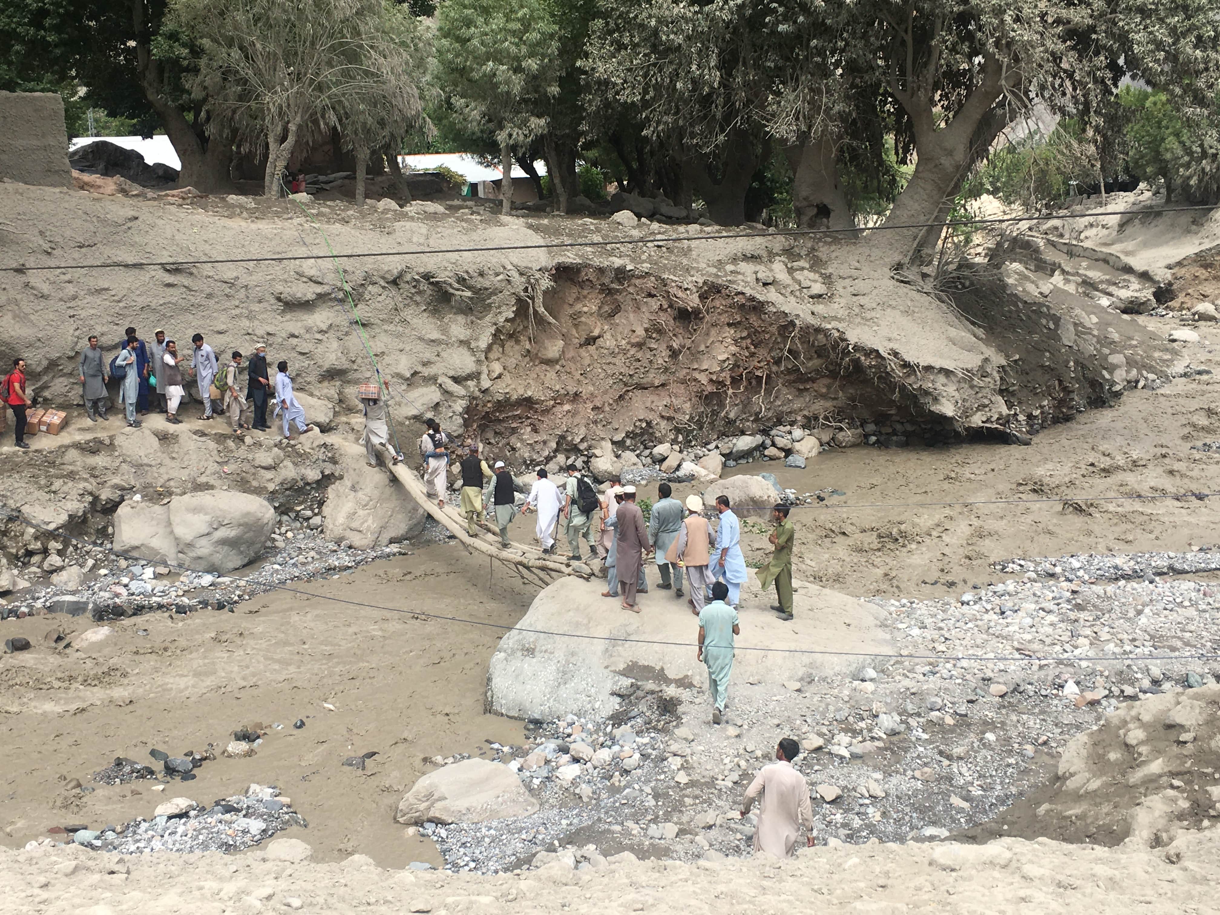 Villagers are waiting for their turn to cross the Chitral River through a makeshift span on Saturday, Aug. 29, 2020, after flash floods destroyed the sole bridge in Reshun, Upper Chitral district, Khyber Pakhtunkhwa. The town is surrounded by four big glaciers. Their melting in recent years has aggravated the spell of floods. (AN photo)