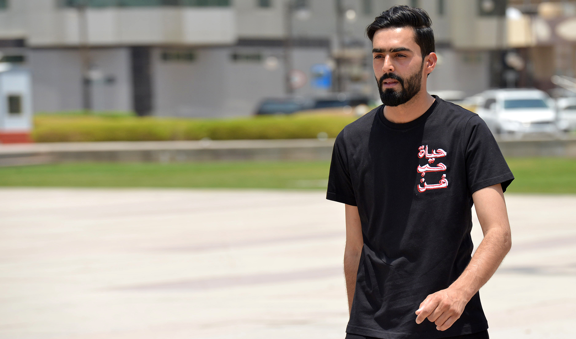 Mohammed Waqas, a Pakistani model and carpenter displays a local brand T-shirt at the King Fahad library park in Riyadh, Saudi Arabia, on July 19, 2020. (AFP/File)