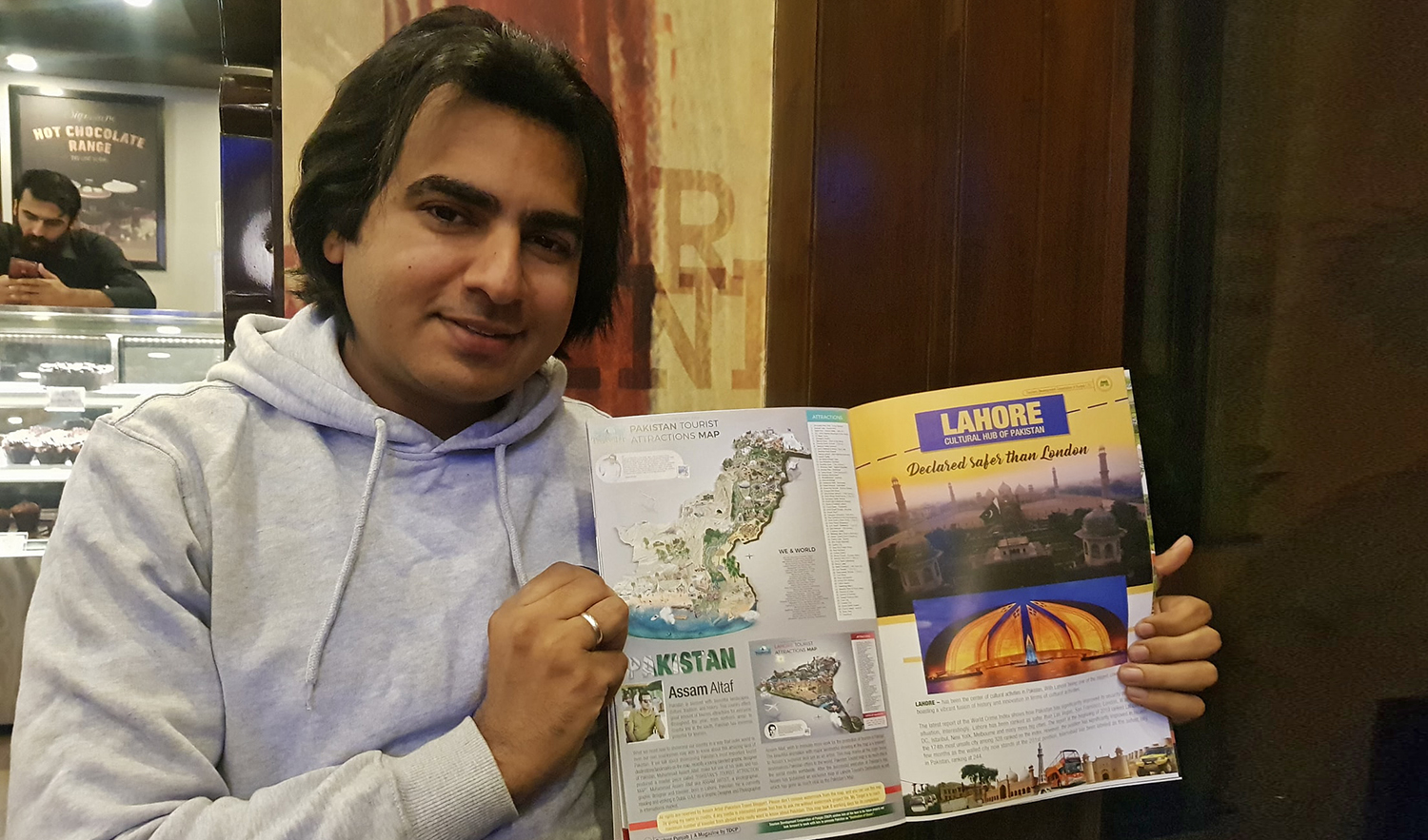 In this photo shared on Jan. 16, 2020 by the Explore Punjab magazine of the Tourism Development Corporation Punjab (TDCP), Dubai-based Pakistani graphic designer Mohammad Assam Altaf poses with his map of Lahore.