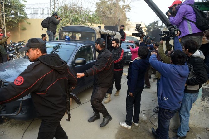 Pakistani policemen escort the police van carrying a suspect accused of raping and murdering a young girl as they leave an anti-terrorist court in Lahore on Jan. 24, 2018. (AFP)