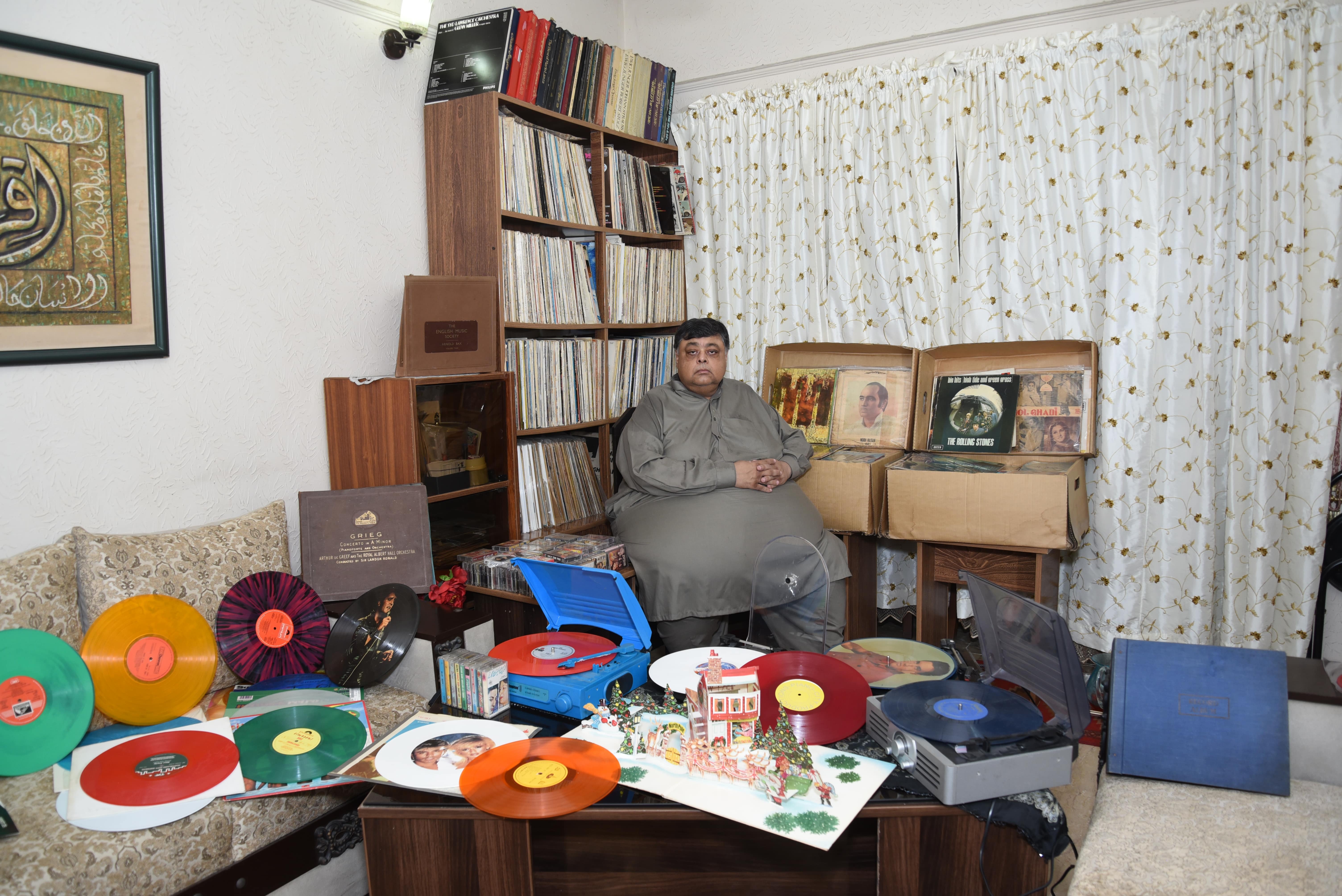 Naeem-ud-Din Ahmed is sitting among some of his 15,000 vinyl records in Lahore on Sept. 12, 2020. (AN photo)