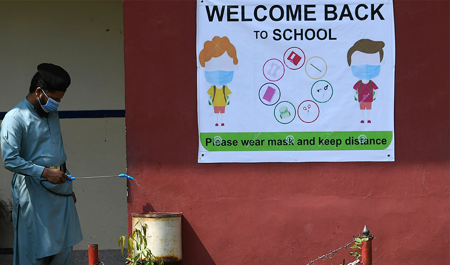 A worker sprays disinfectant at a government school building in Islamabad on September 14, 2020 following the government's announcement to reopen educational institutes starting from September 15, nearly six months after the spread of the Covid-19 coronavirus. (AFP)