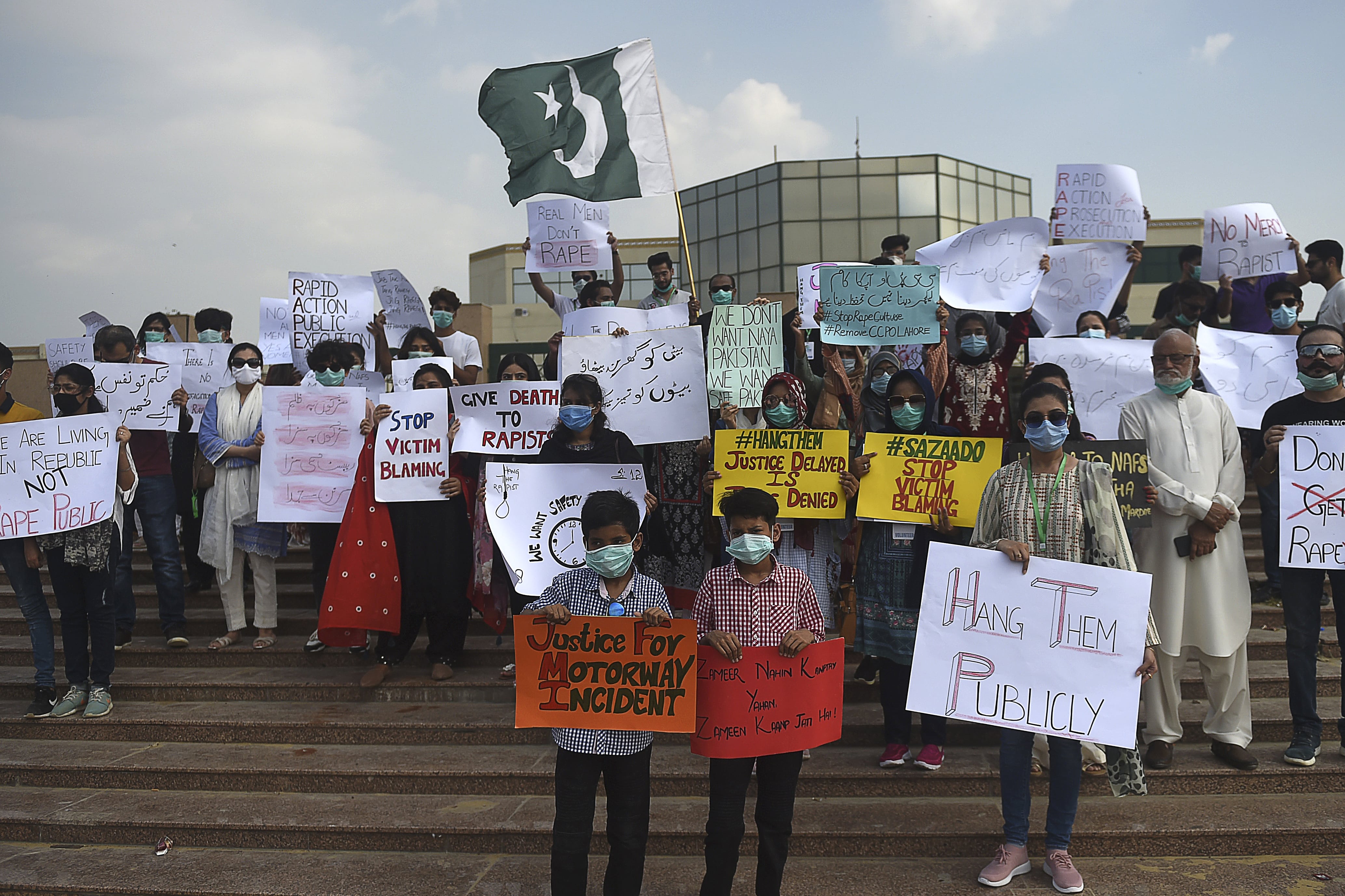 Members of VCare Welfare Trust hold placards during a protest against an alleged gang rape of a woman, in Karachi on September 13, 2020. (AFP)