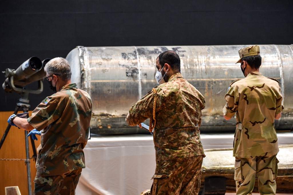 In this undated file photo, representatives of the Saudi-led coalition in Yemen take pictures of Iranian weapons seized by Saudi forces from Yemen's Houthis. (AFP/File)