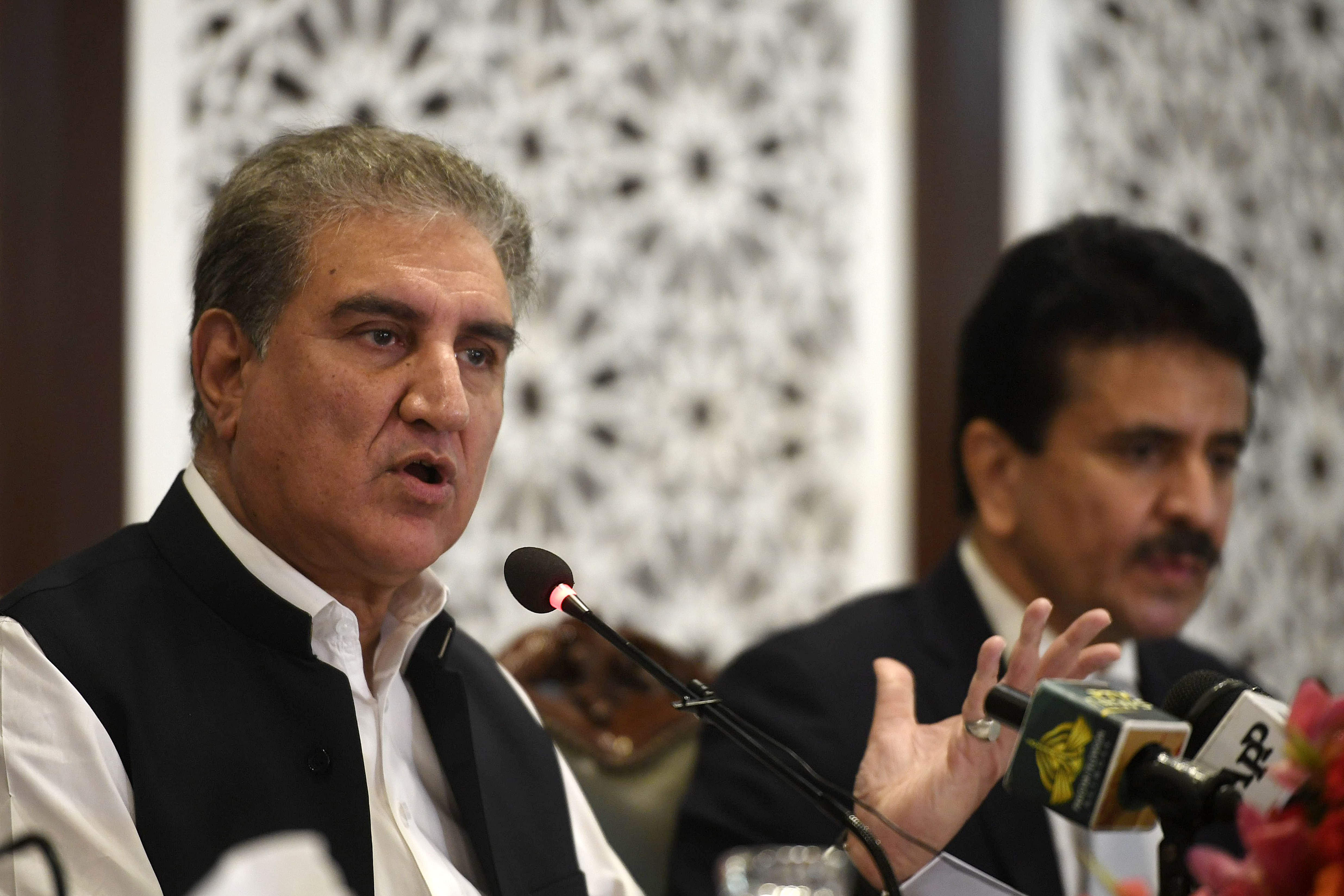 Pakistan's Foreign Minister Shah Mahmood Qureshi (L) speaks during a press conference at the Foreign Ministry in Islamabad on August 24, 2020. (AFP)