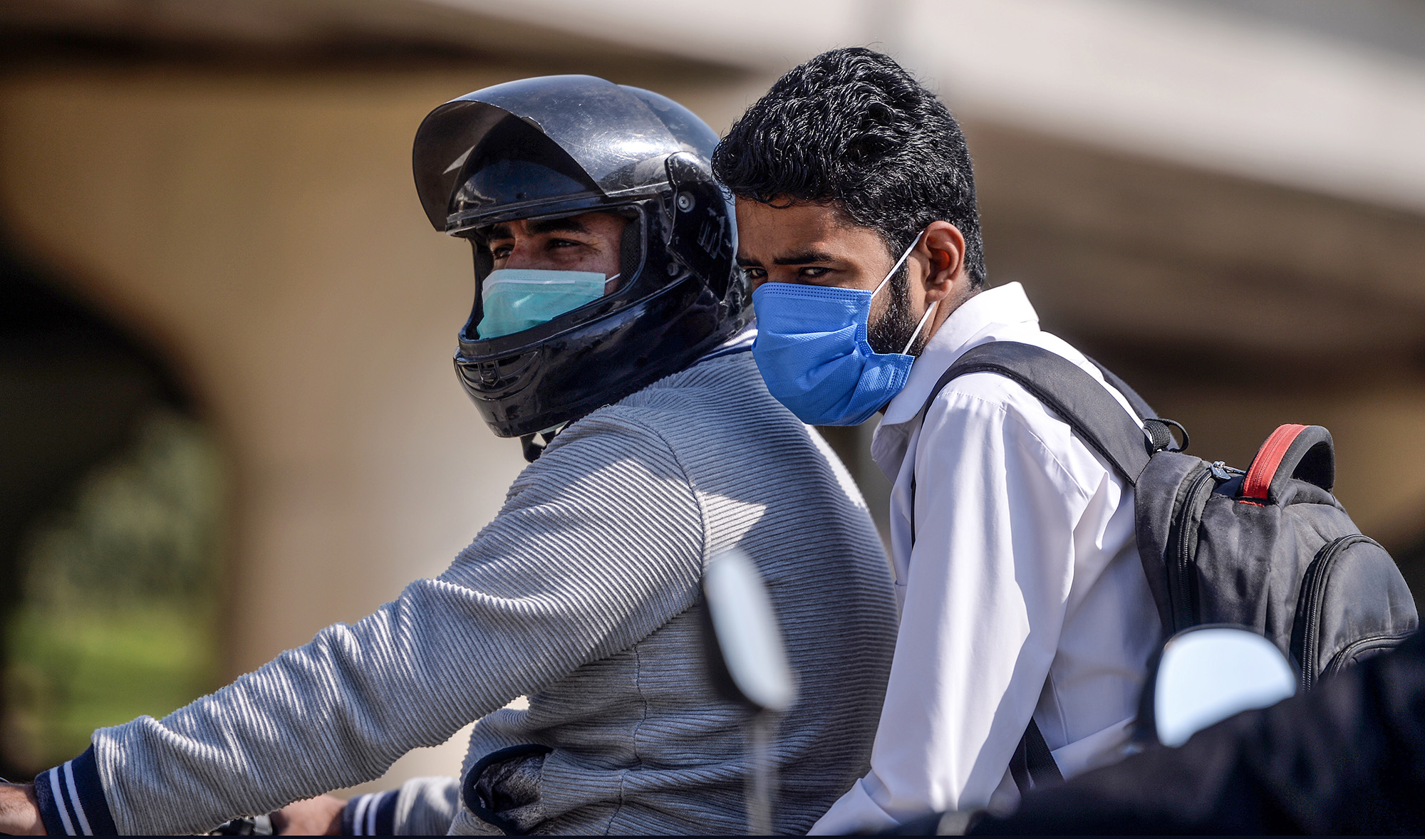 Motorcyclists wearing facemasks as a preventive measure against the COVID-19 coronavirus, ride on a street in Islamabad on March 19, 2020. (AFP/File)