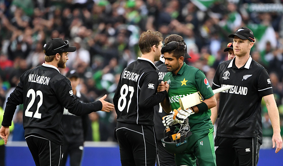 FILE PHOTO: Pakistan's Babar Azam (2R) shakes hands with New Zealand's Lockie Ferguson (2L) and New Zealand's captain Kane Williamson (L) as he celebrates after victory in the 2019 Cricket World Cup group stage match between New Zealand and Pakistan at Edgbaston in Birmingham, central England, on June 26, 2019. (AFP)