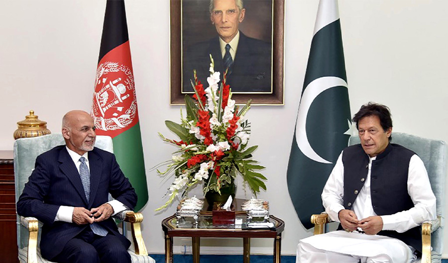 FILE PHOTO: In this handout picture released by Pakistan's Press Information Department (PID) on June 27, 2019, visiting Afghan President Ashraf Ghani (L) talks with Pakistani Prime Minister Imran Khan during a meeting in Islamabad. (AFP)
