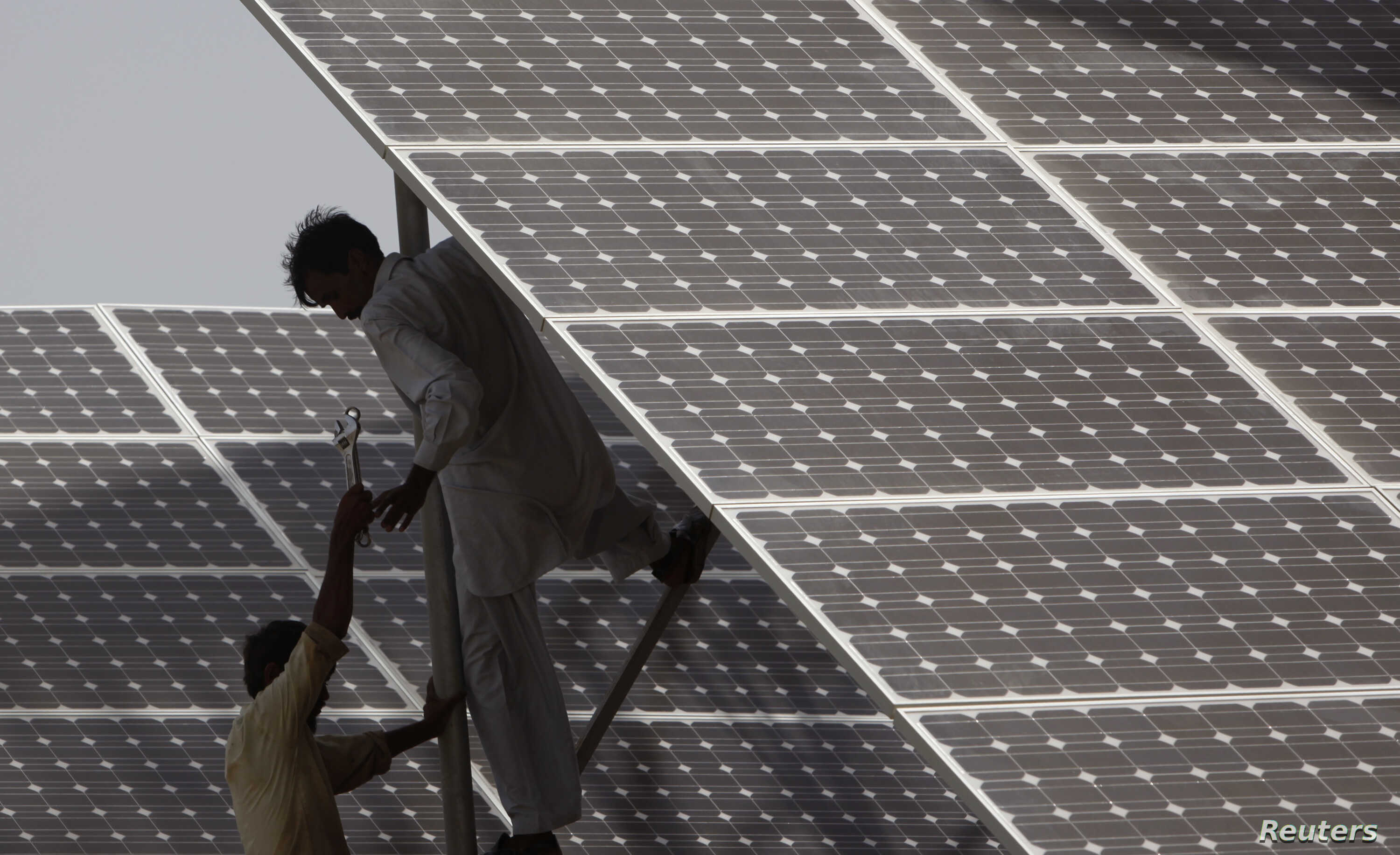 In this file photo, technicians work on solar panel in power station at Hub about 25 km from Karachi on June 18, 2010. Pakistan plans to increase the share of its power generation coming from renewable sources to 20 percent by 2025, and to 30 percent by 2030. (REUTERS/File)
