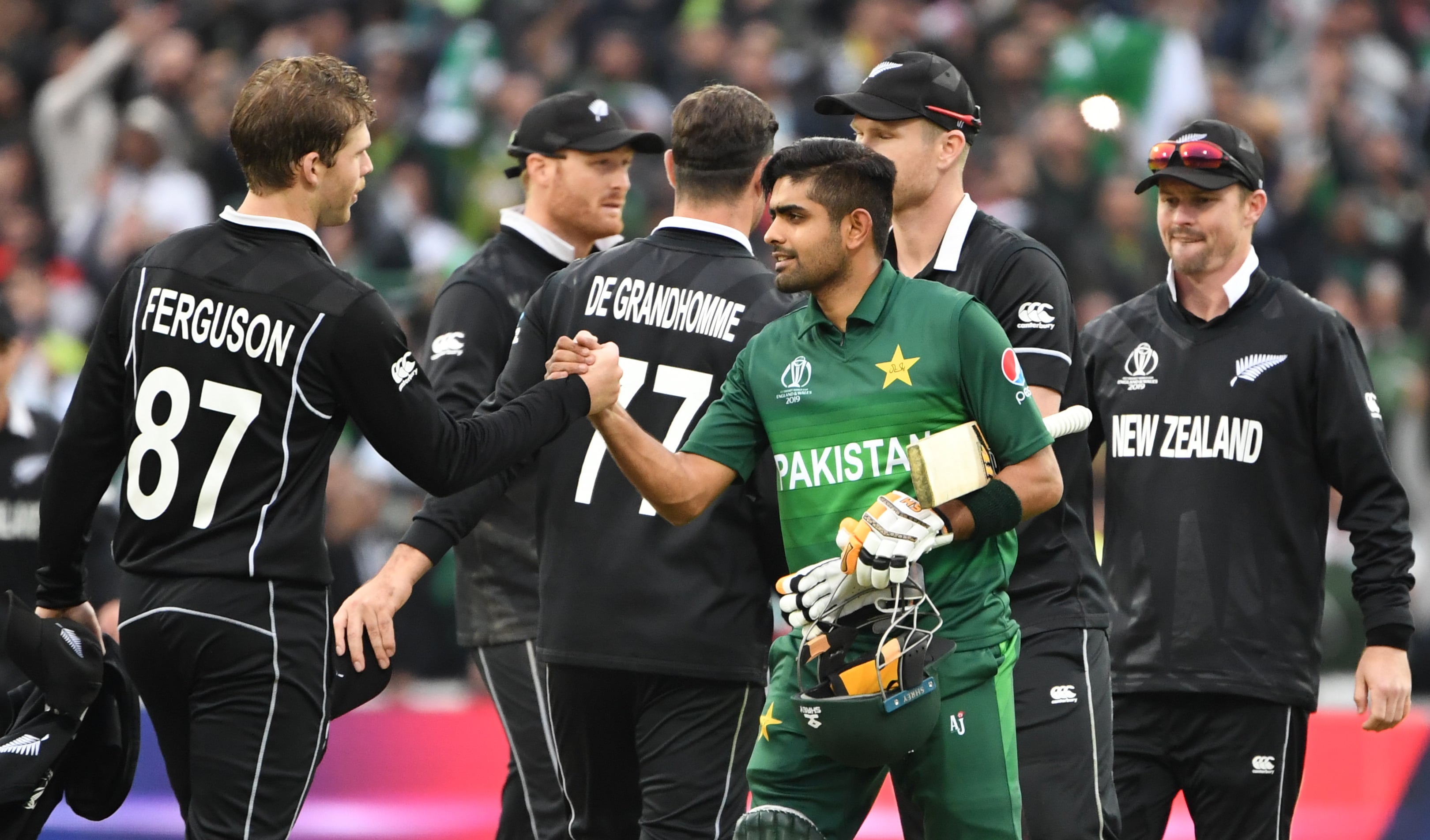 Pakistan's Babar Azam (3R) shakes hands with New Zealand's Lockie Ferguson (L) as he celebrates after victory in the 2019 Cricket World Cup group stage match between New Zealand and Pakistan at Edgbaston in Birmingham, central England, on June 26, 2019. (AFP)