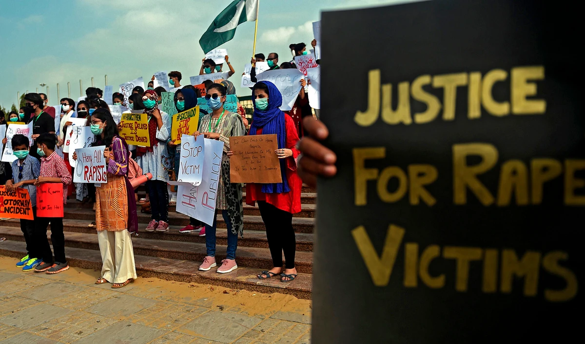 Members of VCare Welfare Trust hold placards during a protest against an alleged gang rape of a woman, in Karachi on Sept. 13, 2020. (AFP)