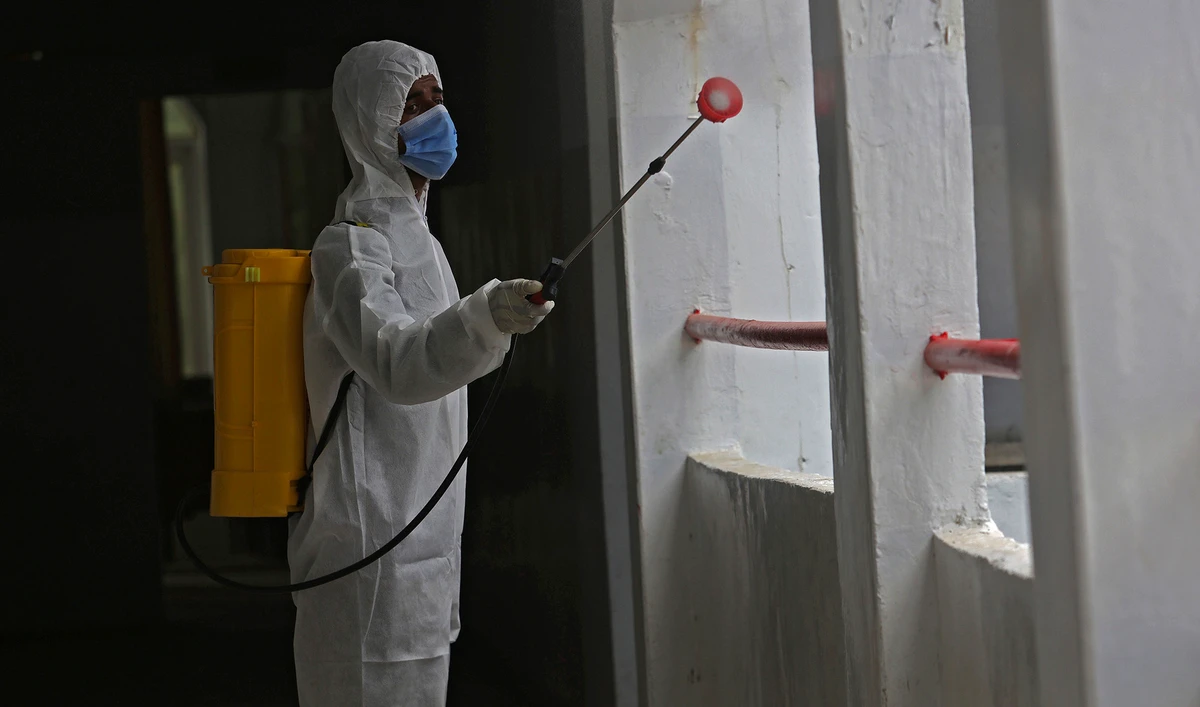 A worker sprays disinfectant in a school as preparations for reopening of educational institutions that were closed in March are finalized, in Karachi, Pakistan, Monday, Sept. 14, 2020. (AP)