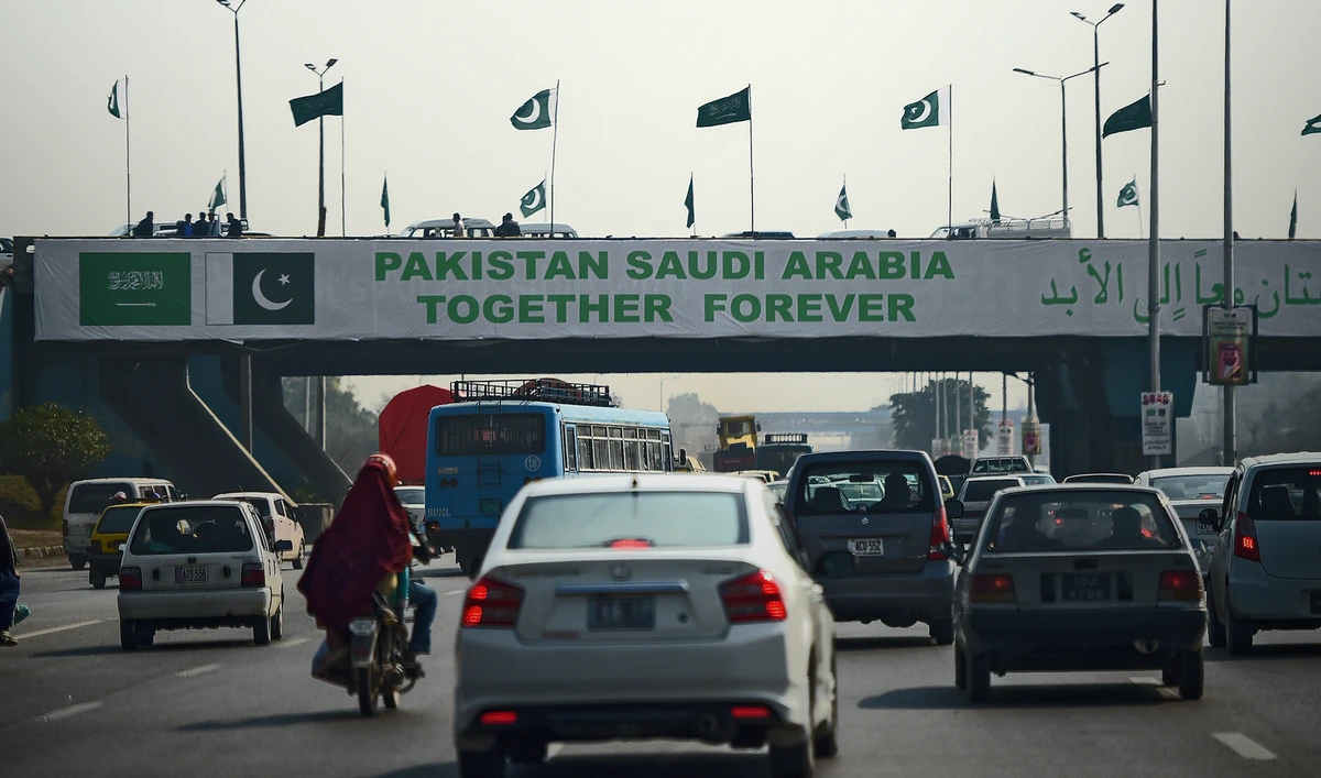 Pakistani commuters drive their vehicles under a banner welcoming Saudi Arabian Crown Prince Mohammed bin Salman displayed on a bridge, ahead of his arrival, in Islamabad on Feb. 15, 2019. (AFP/File)