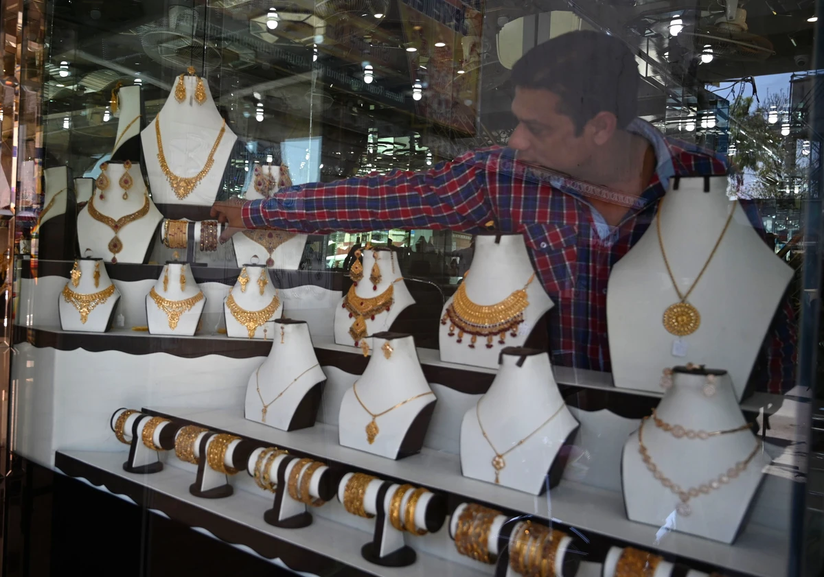 In this pictures taken on April 22, 2019, a Pakistani jeweller arranges jewellery in a window at his shop in Rawalpindi. (AFP)