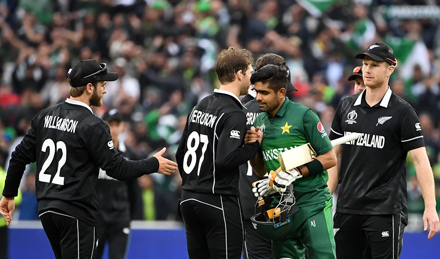FILE PHOTO: Pakistan's Babar Azam (2R) shakes hands with New Zealand's Lockie Ferguson (2L) and New Zealand's captain Kane Williamson (L) as he celebrates after victory in the 2019 Cricket World Cup group stage match between New Zealand and Pakistan at Edgbaston in Birmingham, central England, on June 26, 2019. (AFP)