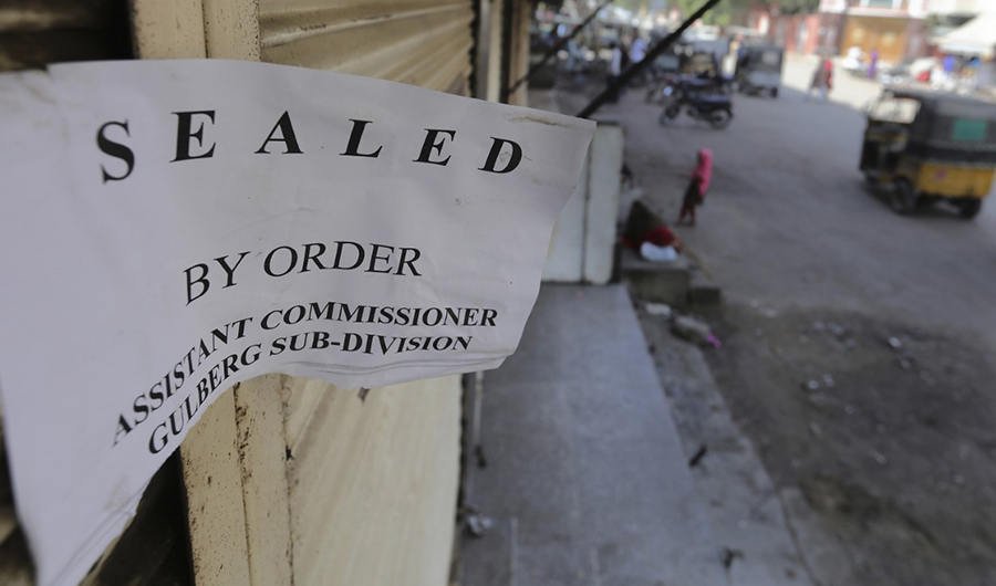A rickshaw drives past a restaurant closed by authorities over violations of social distancing rules for COVID-19, in Karachi, Pakistan, Friday, Oct. 2, 2020. (AP)