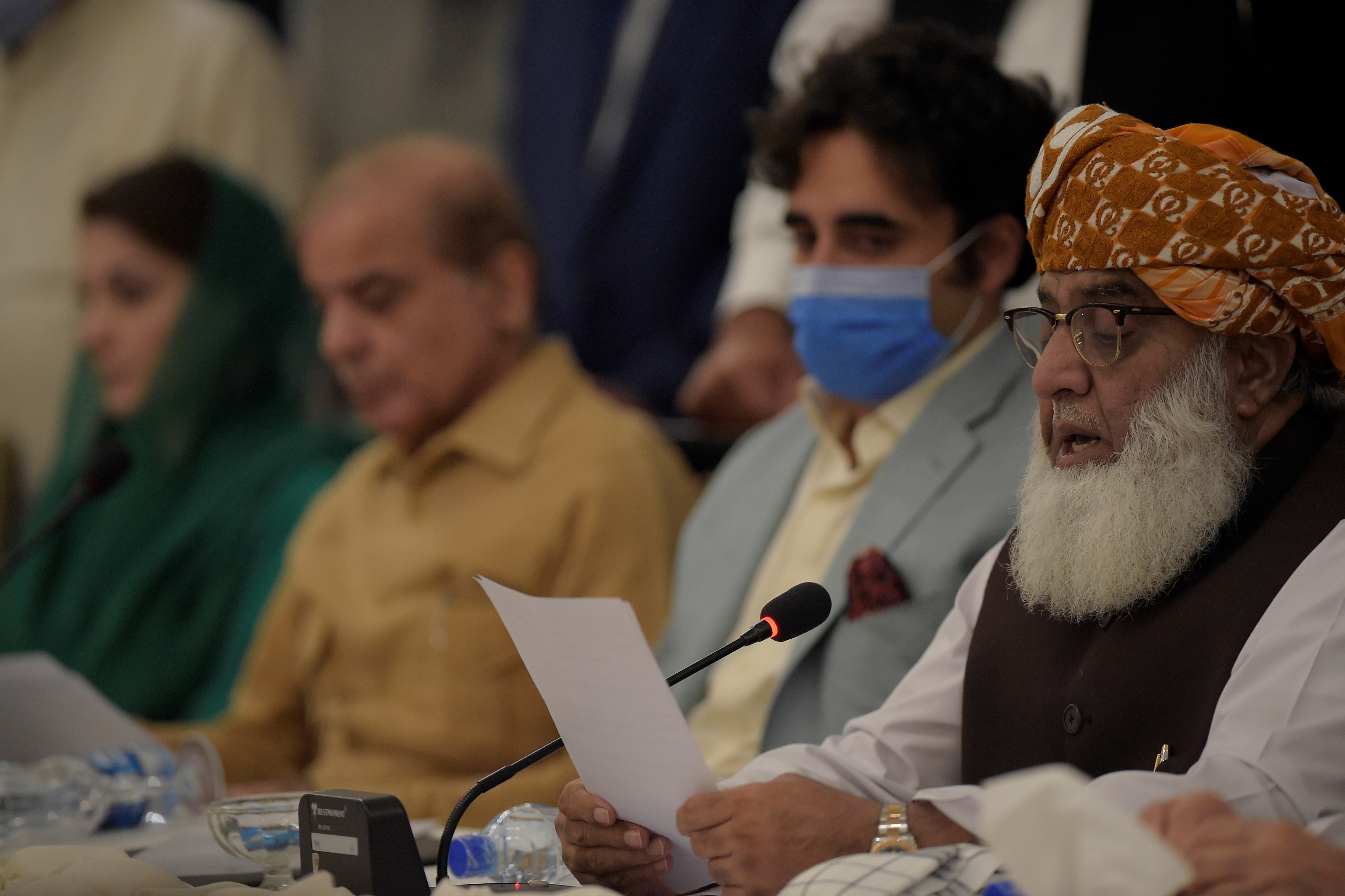 Pakistan opposition leader Mulana Fazal-ur-Rehman (R) reads a copy of a document during a press conference at the end of All Parties Conference (APC) in Islamabad on September 20, 2020, while Bilawal Bhutto Zardari, son of slain former Pakistan premier Benazir Bhutto (2R) and former Pakistani premier Nawaz Sharif brother Shahbaz Sharif (2L), and his daughter Maryam Nawaz Sharif (L) looks on. (AFP)