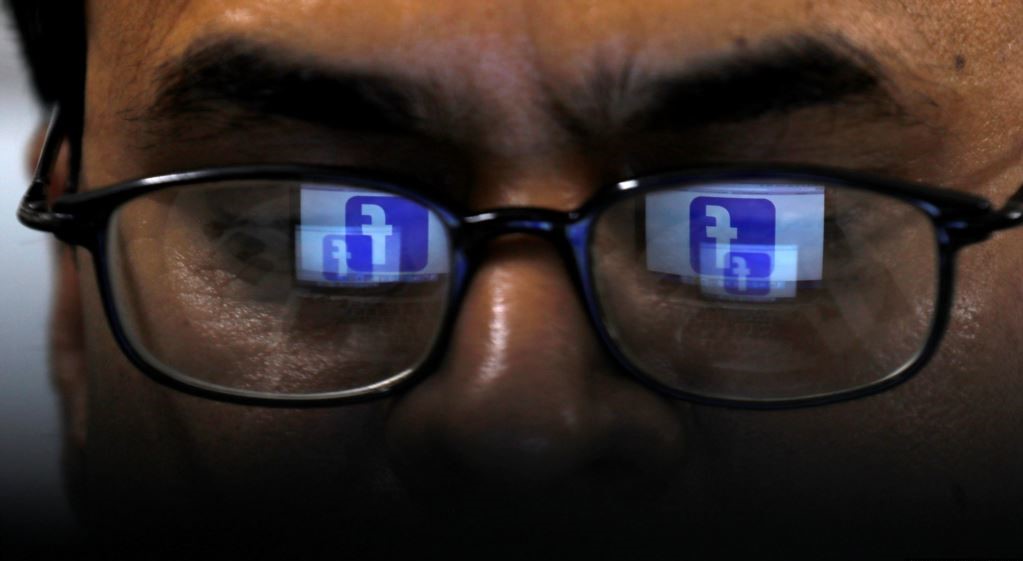 Facebook logo is reflected in glasses of a Pakistani user April 1, 2019. ( Reuters/ File)