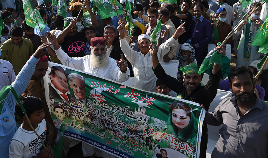 Activists of newly formed Pakistan Democratic Movement (PDM), an opposition alliance of 11 parties, arrive to attend the first public rally in the eastern city of Gujranwala on October 16, 2020. (AFP)