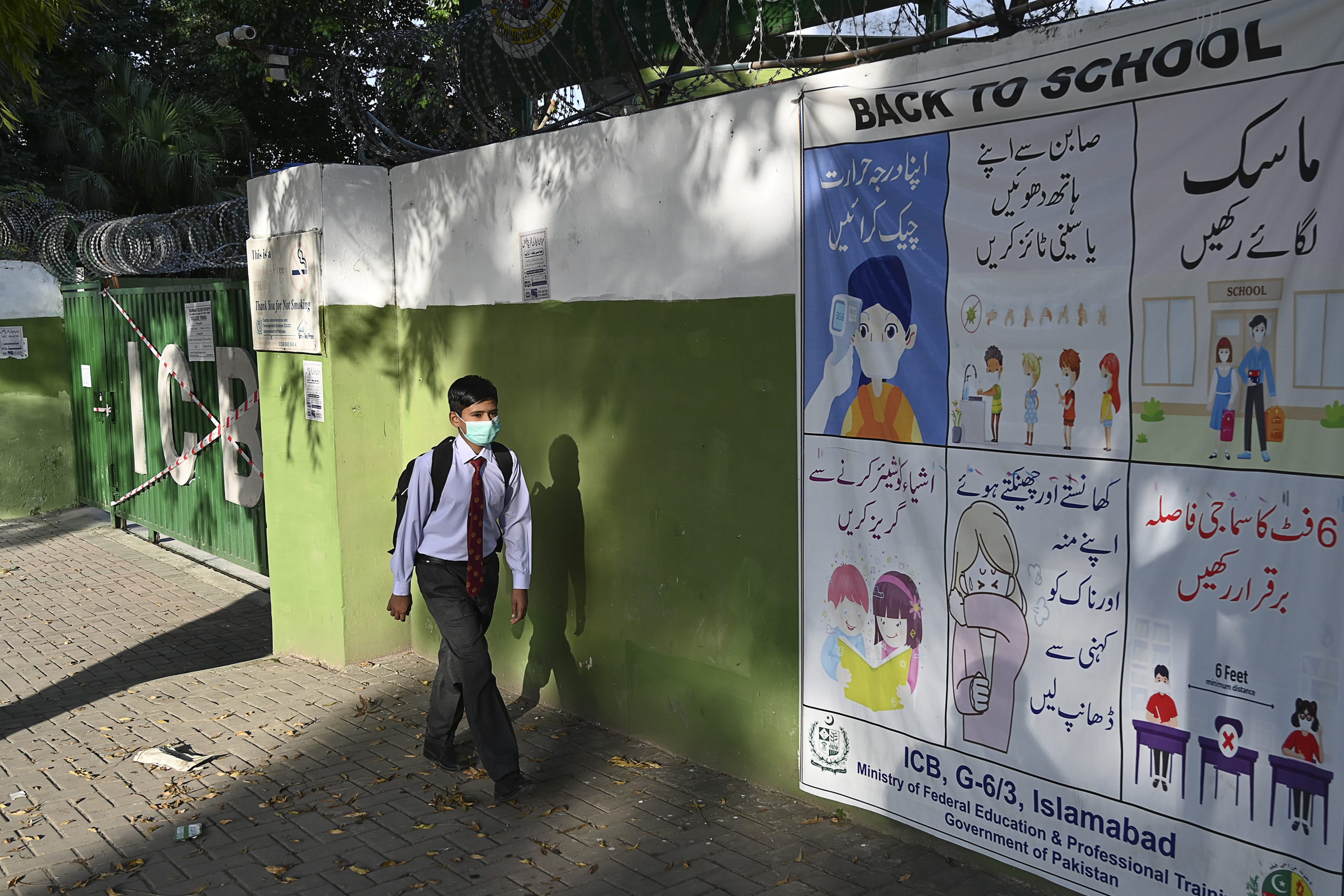 A student wearing a facemask leaves beside a closed school sealed by authorities as some teachers and students tested positive for the Covid-19 Coronavirus in Islamabad on October 5, 2020.(AFP)