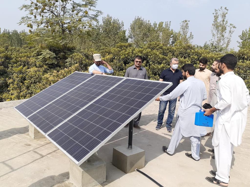 Officials of the Khyber Pakhtunkhwa Energy Development Organization (KPEDO) gather after installing solar panels at a government-run school in Charsadda, Pakistan, on October 12, 2020. (Photo courtesy: KPEDO)