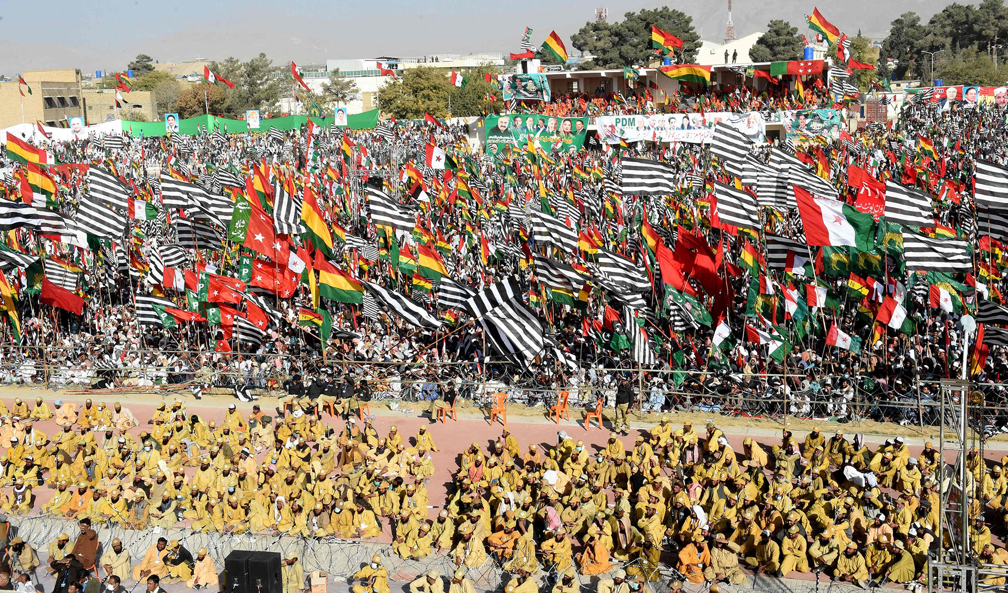 Opposition supporters of Pakistan Democratic Movement (PDM), hold parties flags as they gather during an anti-government rally in Quetta on Oct. 25, 2020. (AFP)
