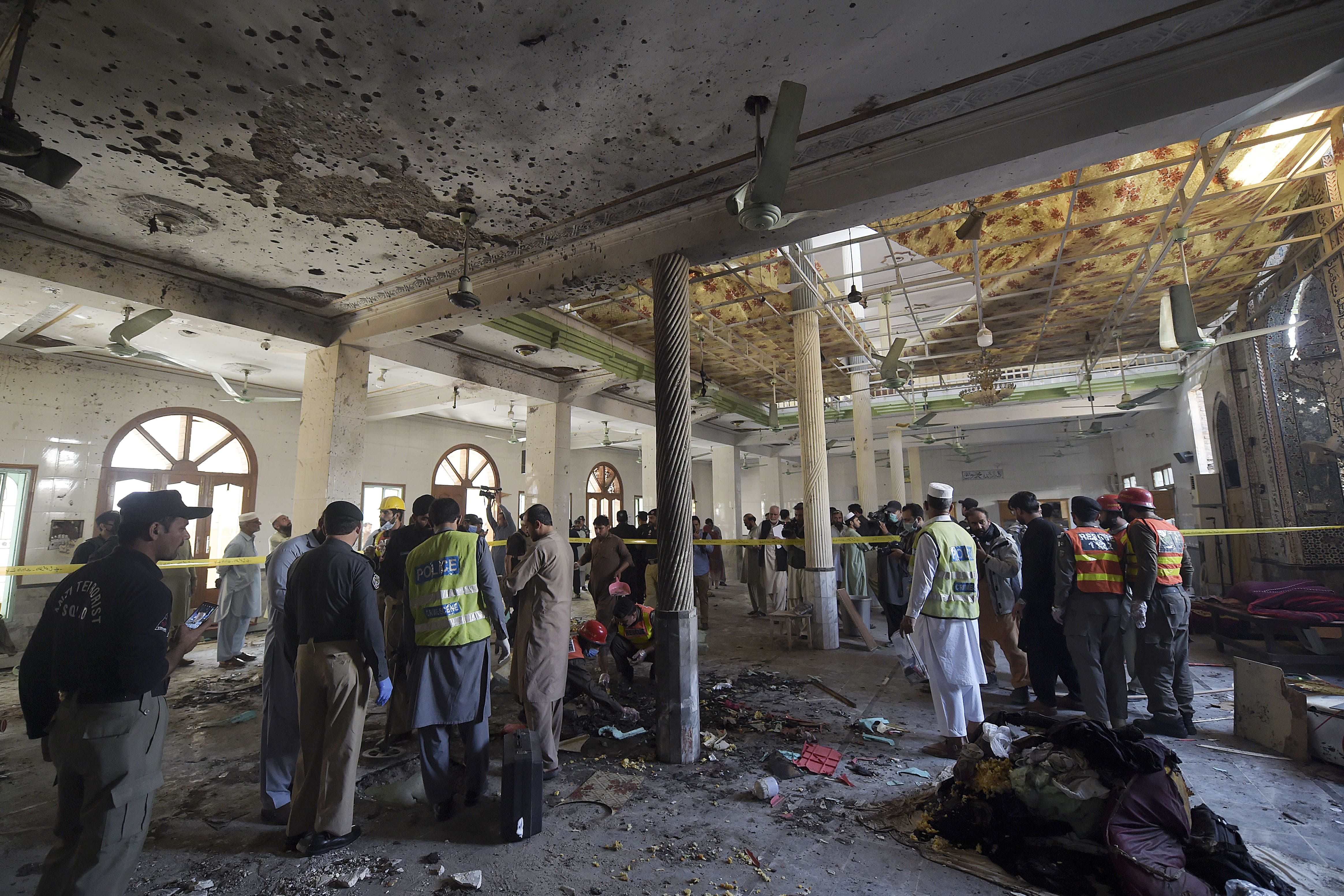 Security officials examine the site of a blast at a religious school in Peshawar on October 27, 2020. At least four students were killed and dozens more wounded on October 27 when a bomb exploded during a class at their religious school in Pakistan, officials said. (AFP)