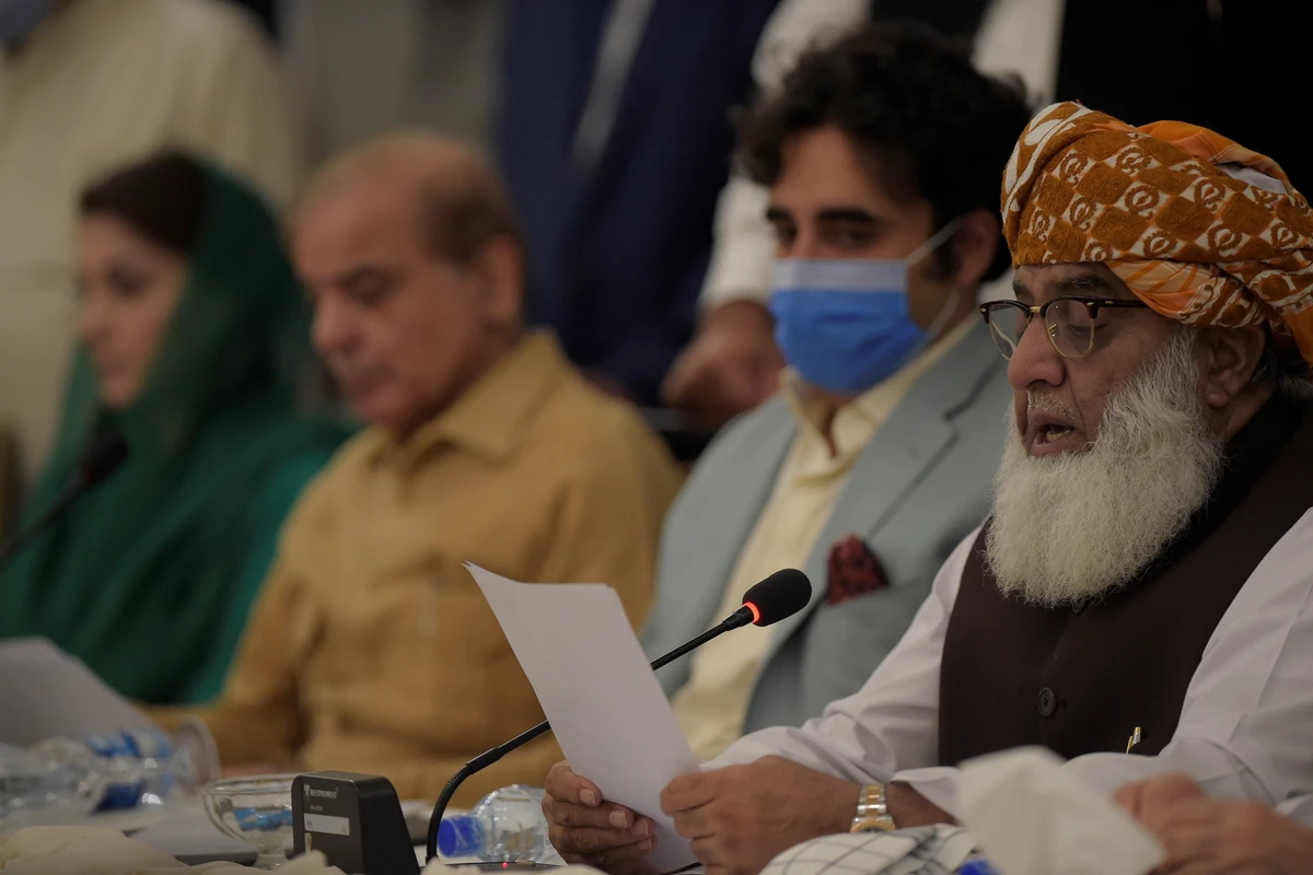 Pakistan opposition leader Mulana Fazal-ur-Rehman (R) reads a copy of a document during a press conference at the end of All Parties Conference (APC) in Islamabad on September 20, 2020, while Bilawal Bhutto Zardari, son of slain former Pakistan premier Benazir Bhutto (2R) and former Pakistani premier Nawaz Sharif brother Shahbaz Sharif (2L), and his daughter Maryam Nawaz Sharif (L) looks on. (AFP)