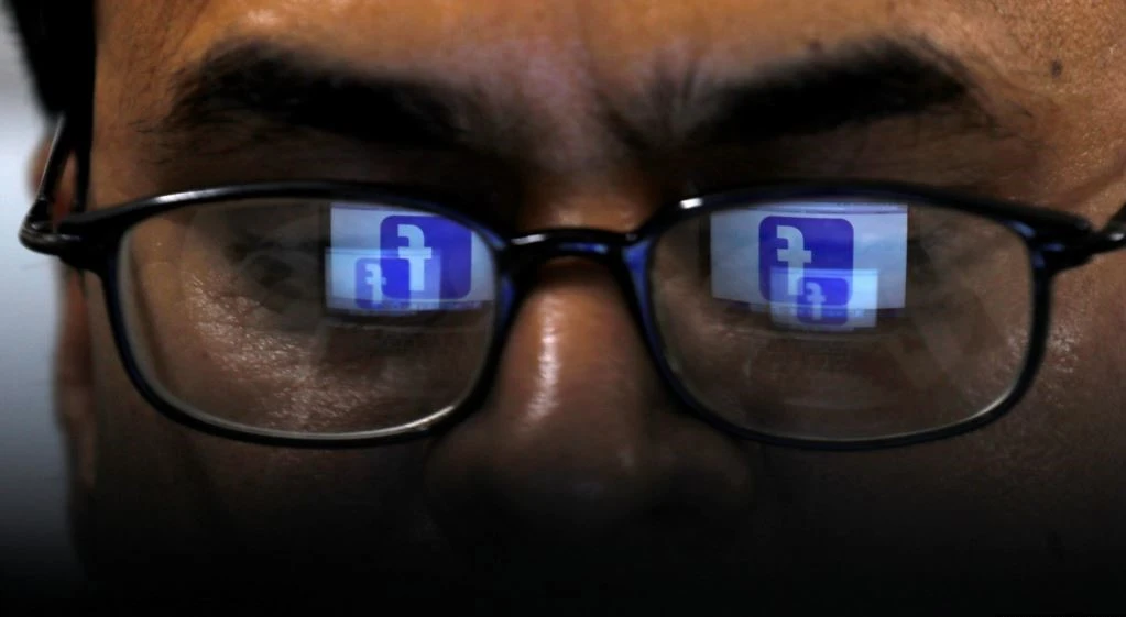Facebook logo is reflected in glasses of a Pakistani user April 1, 2019. ( Reuters/ File)