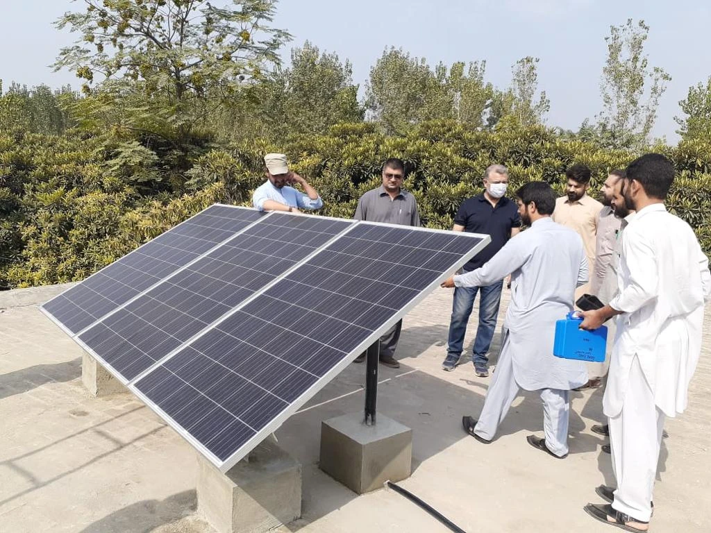Officials of the Khyber Pakhtunkhwa Energy Development Organization (KPEDO) gather after installing solar panels at a government-run school in Charsadda, Pakistan, on October 12, 2020. (Photo courtesy: KPEDO)