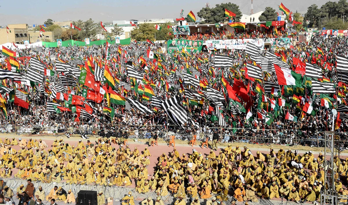 Opposition supporters of Pakistan Democratic Movement (PDM), hold parties flags as they gather during an anti-government rally in Quetta on Oct. 25, 2020. (AFP)