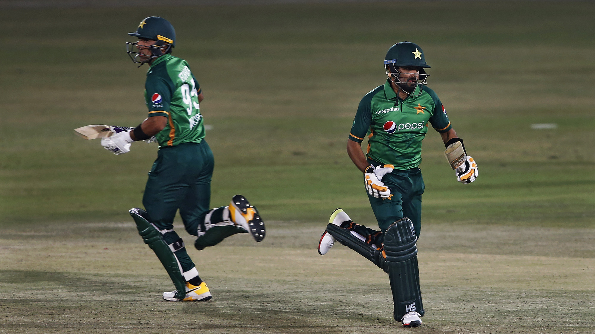 Pakistani batsmen Babar Azam, right, and Iftikhar Ahmed run between the wickets during the 2nd one-day international cricket match against Zimbabwe at the Pindi Cricket Stadium, in Rawalpindi on Nov. 1, 2020. (AP)