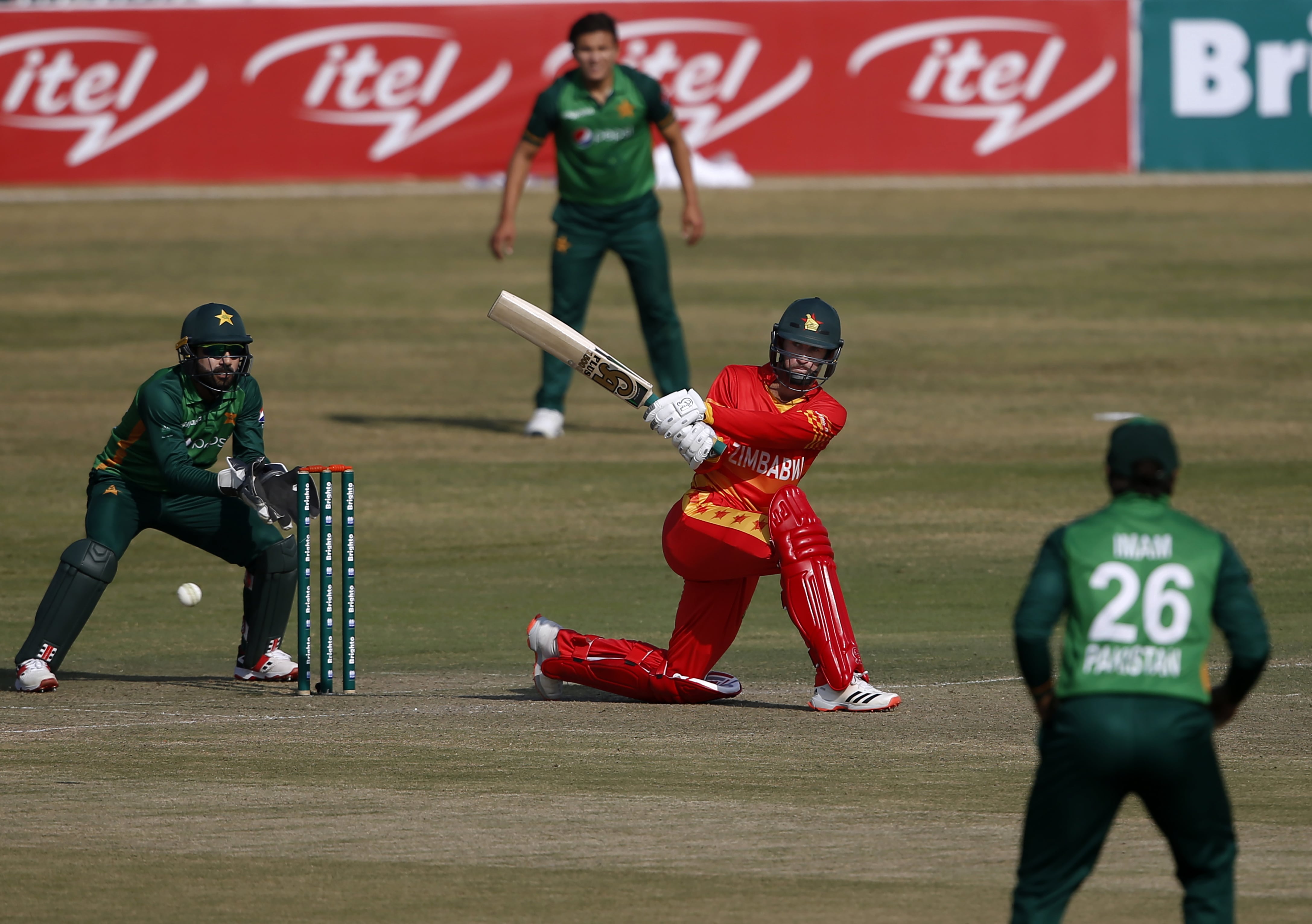 Zimbabwe's batsman Sean Williams, center, plays a shot for boundary while Pakistani wicketkeeper Mohammad Rizwan, left, watch during their 3rd one-day international cricket match at the Pindi Cricket Stadium, in Rawalpindi, Pakistan, Tuesday, Nov. 3, 2020. (AP)