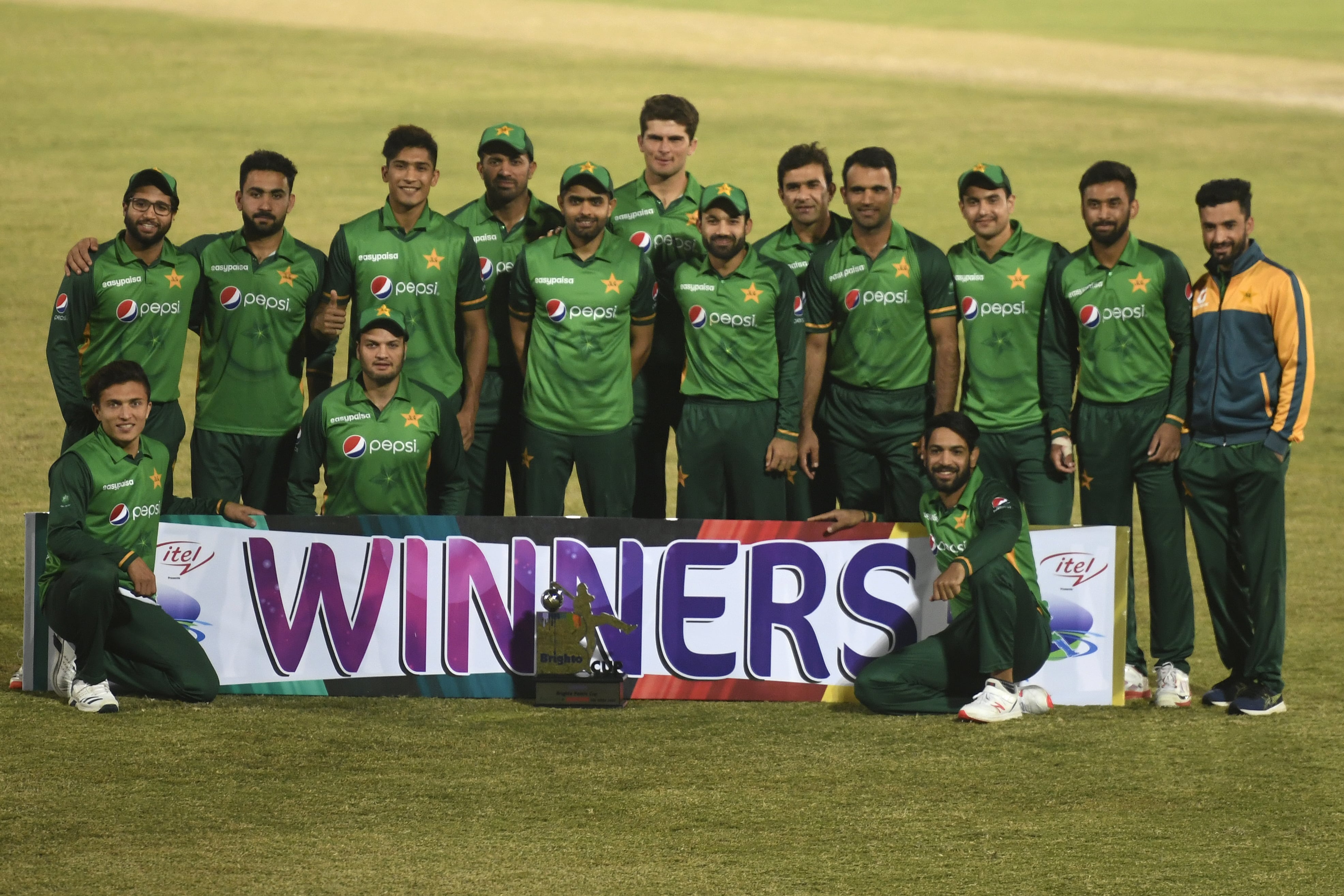 Pakistan's players pose for a picture with the trophy after winning the one-day international (ODI) cricket series against Zimbabwe at the Rawalpindi Cricket Stadium in Rawalpindi on November 3, 2020. (AFP)