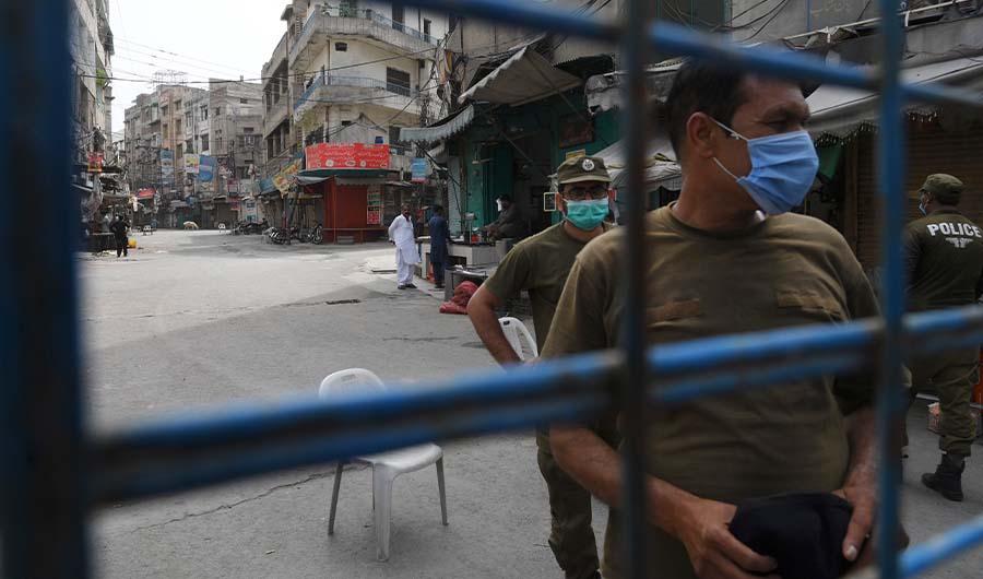 Policemen stand guard at a deserted residential area, which was sealed by the authorities in Lahore on June 19, 2020 after the COVID-19 coronavirus cases continue to rise. (AFP)