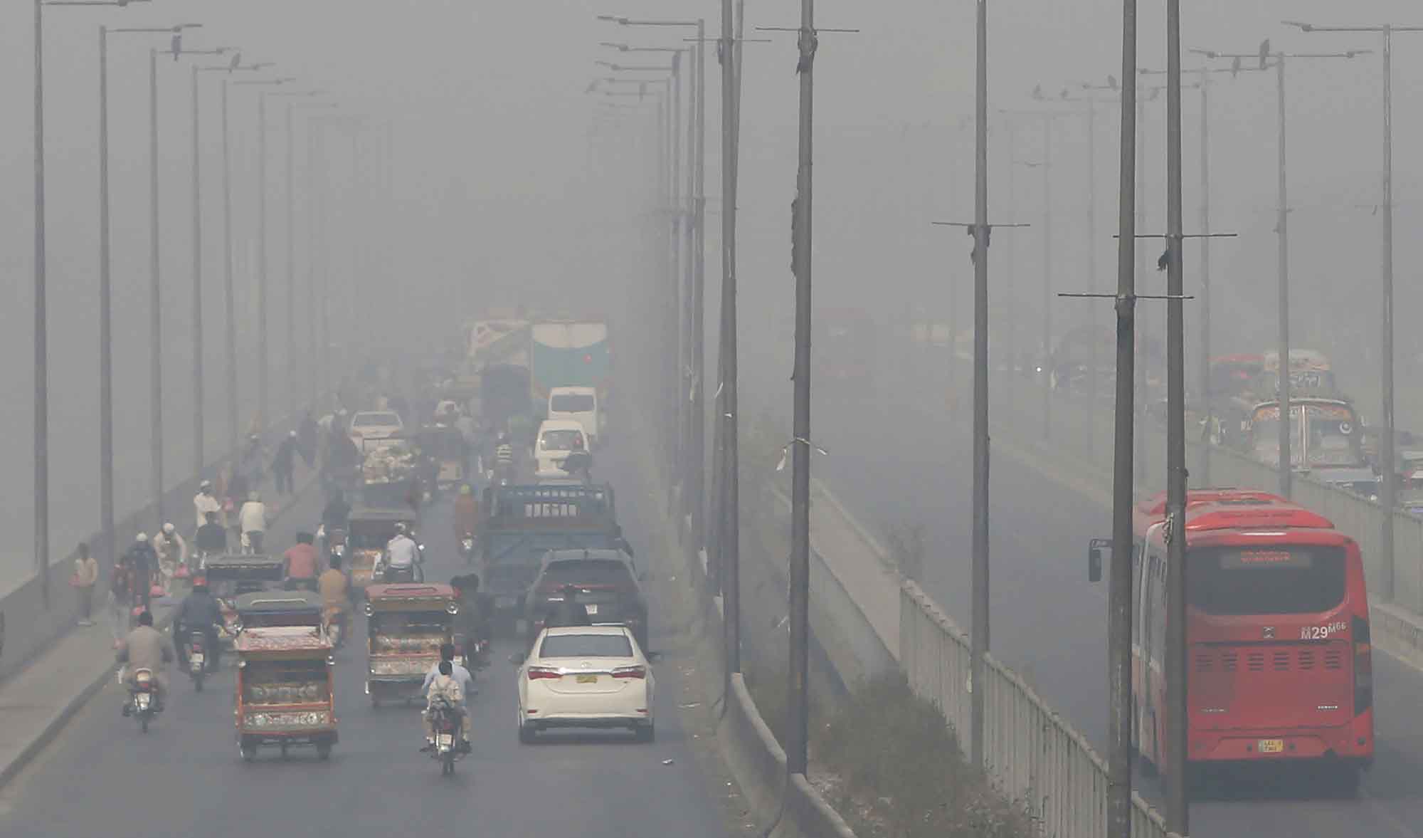 Vehicles drive on a highway in Lahore as smog envelops the city on Nov. 11, 2020. (AP)