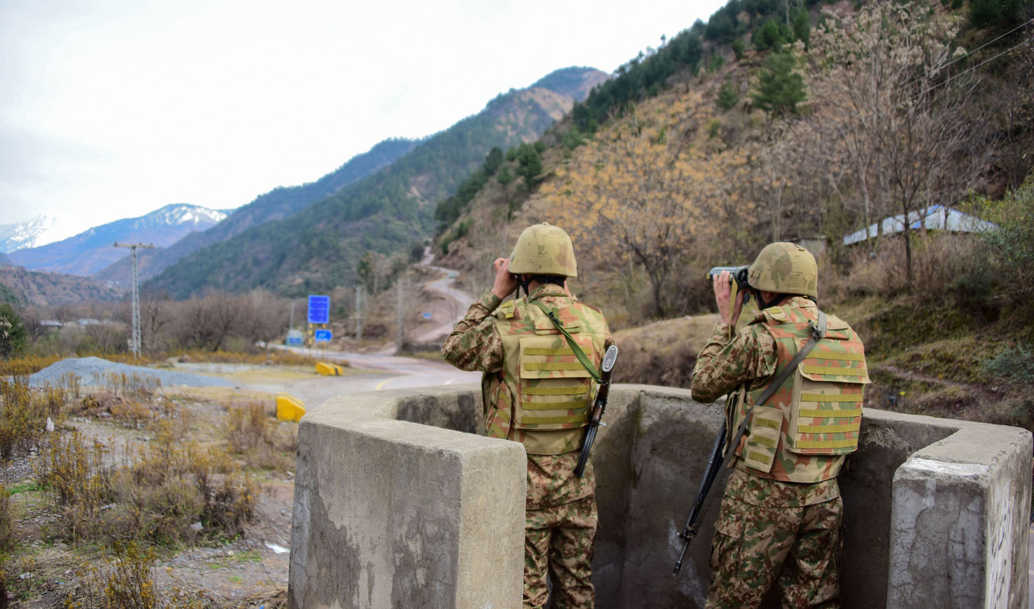 In this file photo, Pakistani soldiers watch over potential Indian troop movements with binoculars in a bunker at the Chakothi post, some 52 km from Muzaffarabad near Pakistan-India border on Feb. 23, 2019. (AFP)