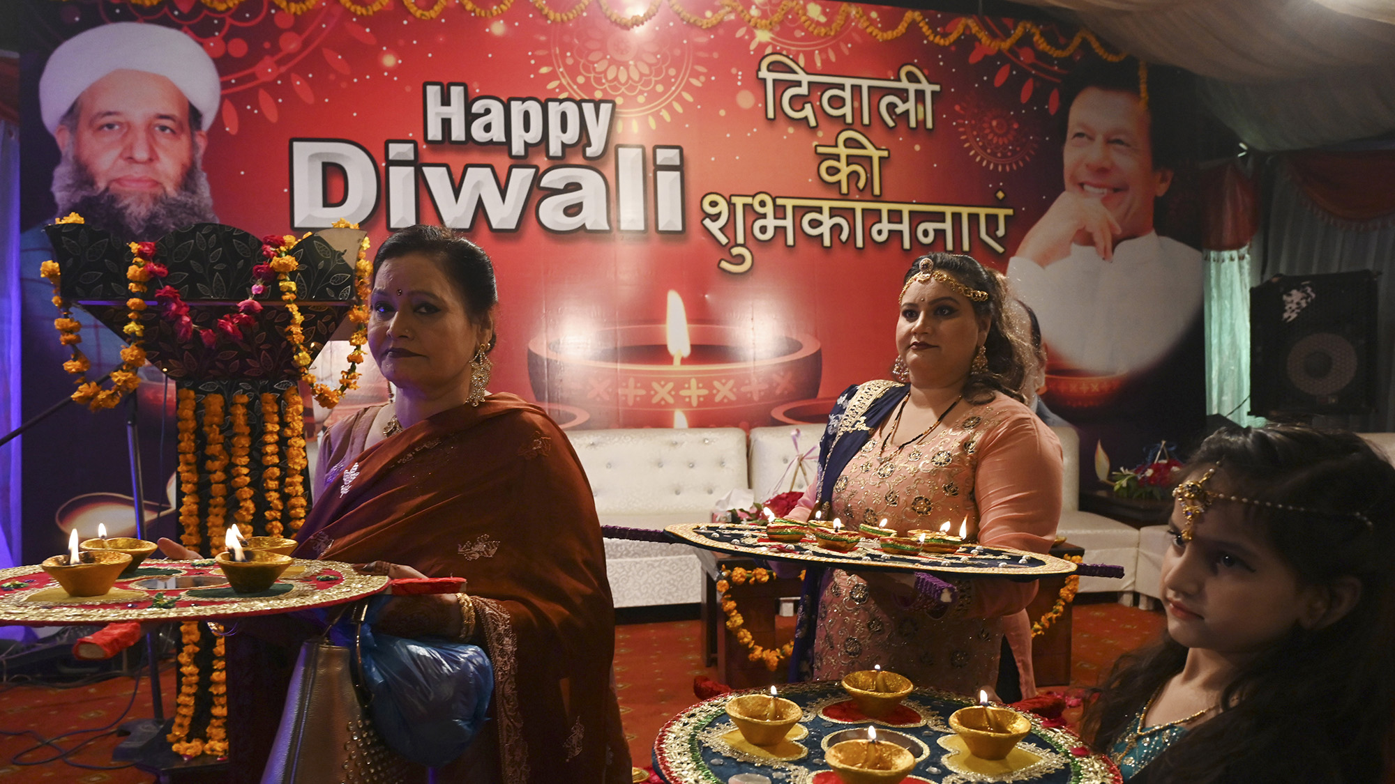 Pakistani Hindu women celebrate Diwali, the Hindu Festival of Lights, at Krishna Mandir in Lahore on Nov. 14, 2020. (AFP)