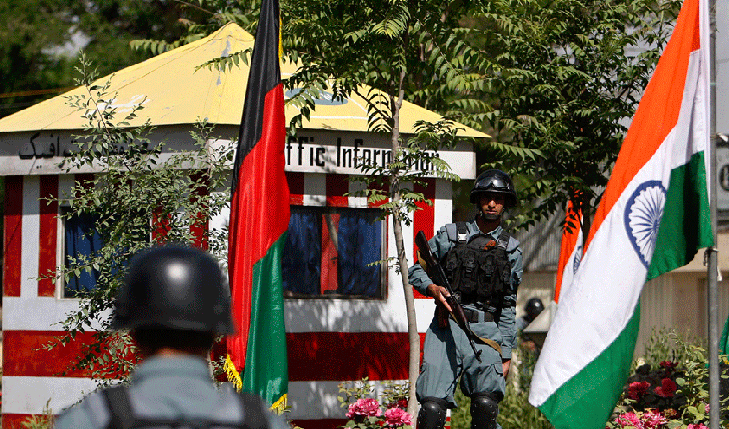 This undated photograph shows Afghan policemen stand guard next to Indian and Afghan national flags, at a check point in Kabul city. (REUTERS/File)