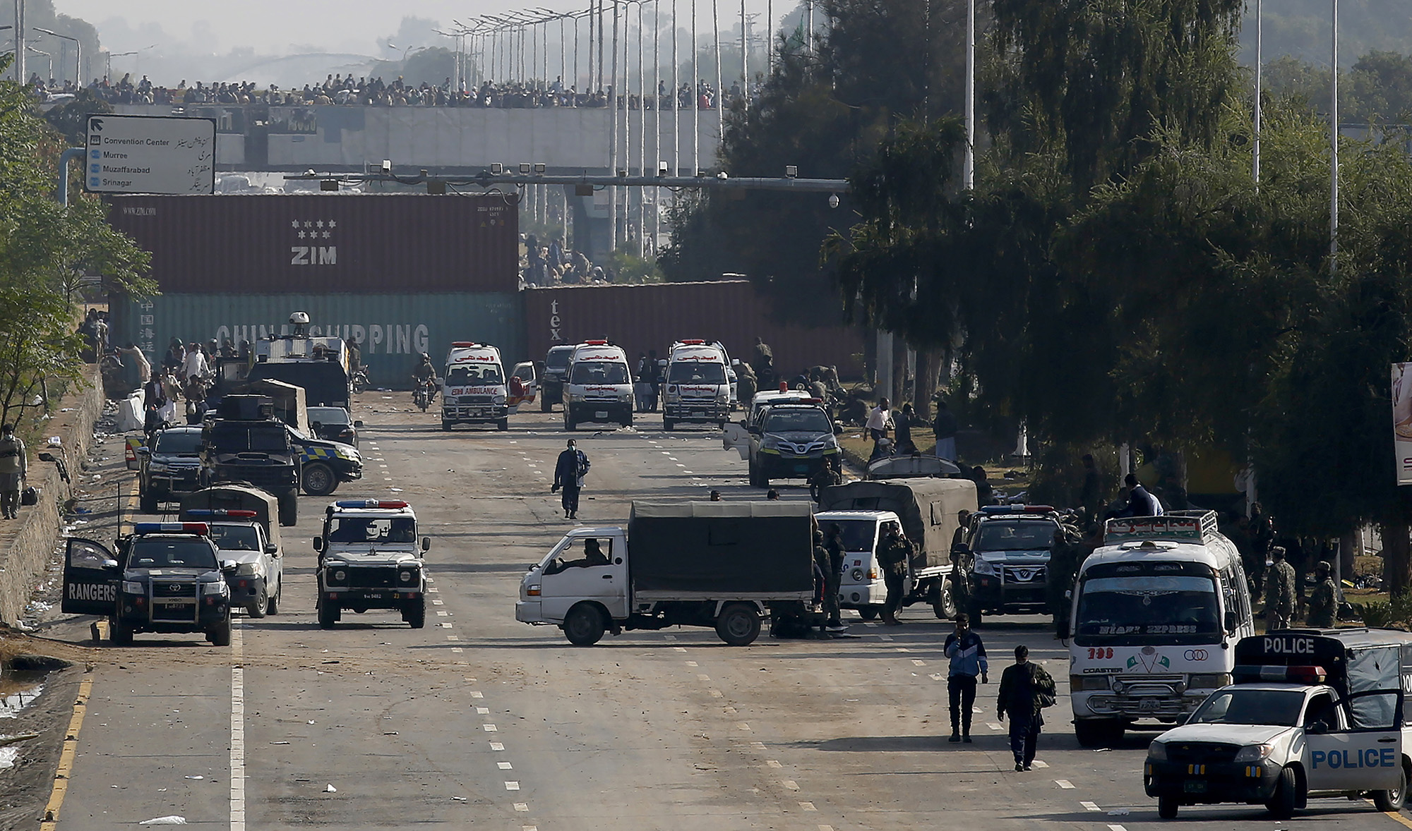 Security vehicles park near shipping containers placed by authorities on a highway to stop supporters of the 'Tehreek-e-Labaik Pakistan, a religious political party, entering into the capital during an anti-France rally in Islamabad on Nov. 16, 2020. (AP)