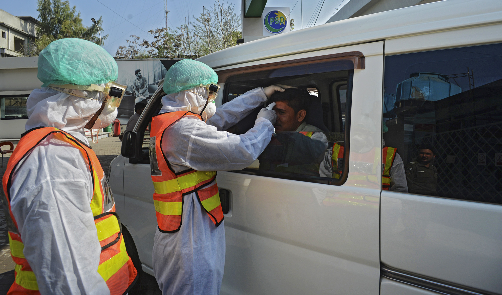 A Pakistani rescue personnel checks the body temperature of a man during a drill exercise as a preventive measure for the spread of the of COVID-19 coronavirus, in Peshawar on March 1, 2020. (AFP/File)