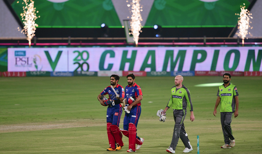 Karachi King's Babar Azam (L) along with teammate Imad Wasim (2nd-L) walk out of the pitch after winning the Pakistan Super League (PSL) Twenty20 cricket final match between the Karachi Kings and Lahore Qalandars at the National Stadium in Karachi on November 17, 2020. (AFP)