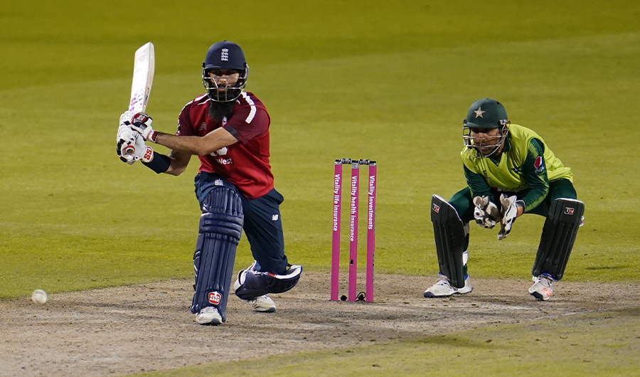 England's Moeen Ali (L) bats away from Pakistan's Sarfaraz Ahmed during the international Twenty20 cricket match between England and Pakistan at Old Trafford cricket ground in Manchester, north-west England, on September 1, 2020. (AFP)